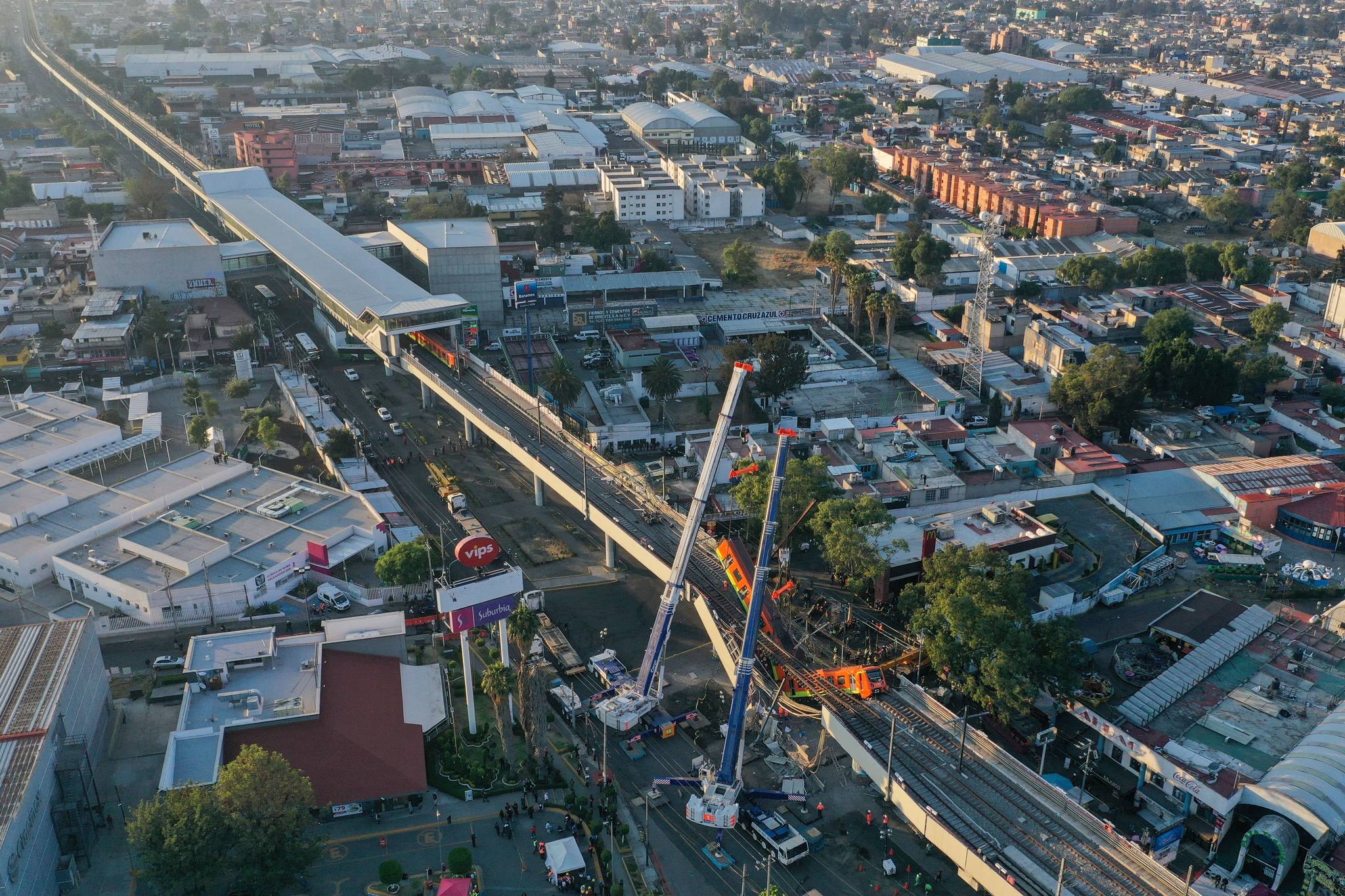 Pedro Pardo / AFP via Getty Images 
An aerial view shows the site of a metro train accident after an overpass for a metro partially collapsed in Mexico City. An elevated metro line collapsed in the Mexican capital on Monday, leaving at least 23 people dead and dozens injured as a train came plunging down, authorities said.