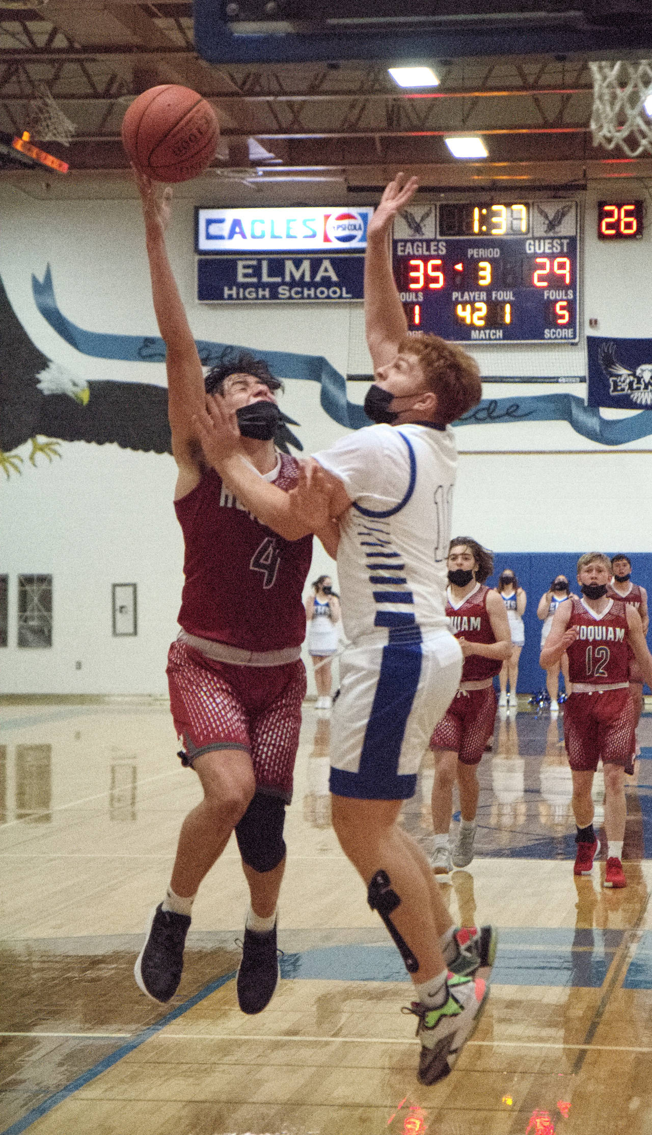 RYAN SPARKS | THE DAILY WORLD Hoquiam’s Abraham Morales (4) is defended by Elma’s Nick Church during Hoquiam’s 66-63 season-opening overtime victory on Friday in Elma.