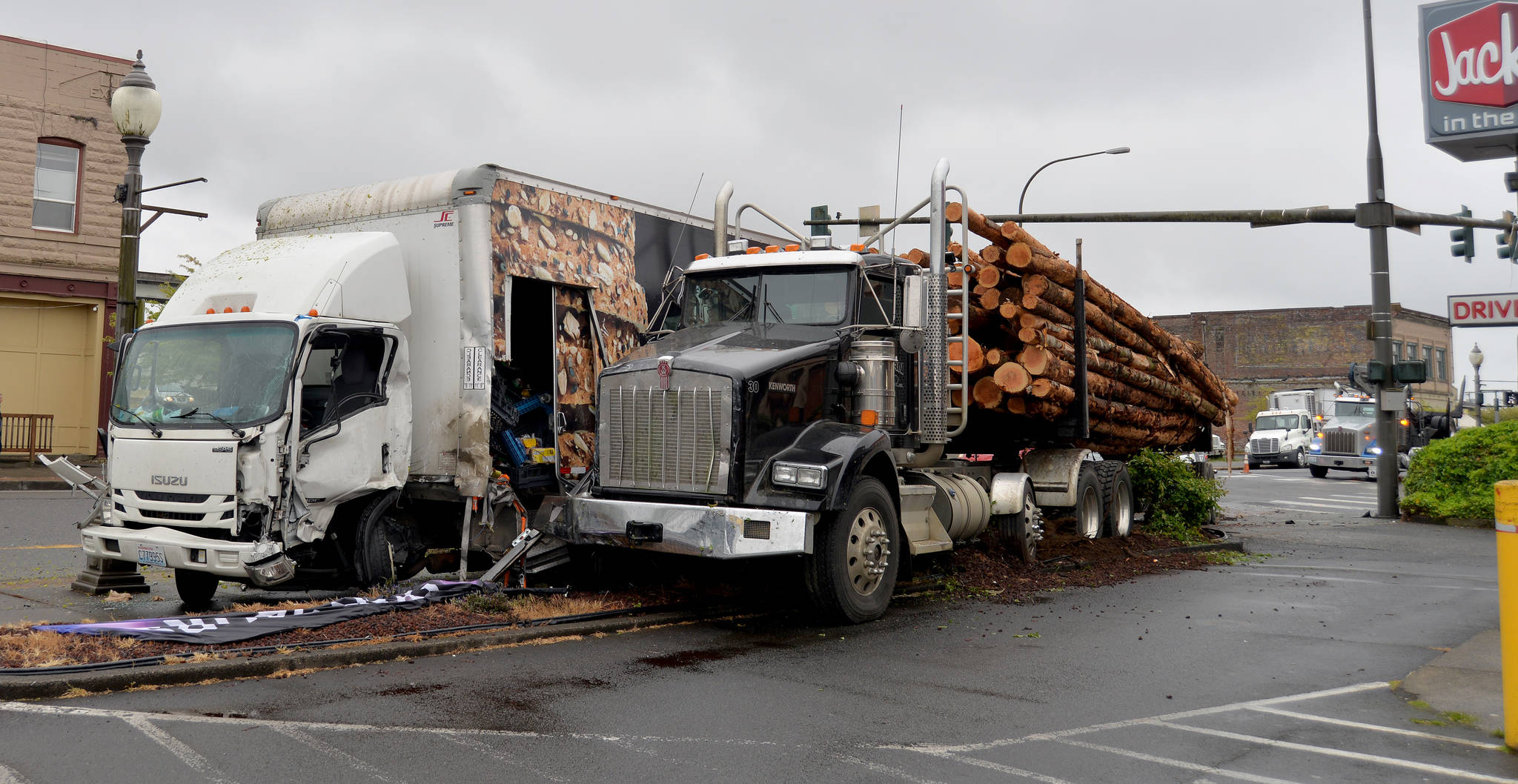 DAVE HAVILAND/THE DAILY WORLD
A box truck driver was transported from the scene for medical evaluation after police say he failed to stop at a flashing red light and collided with a log truck early Monday morning.