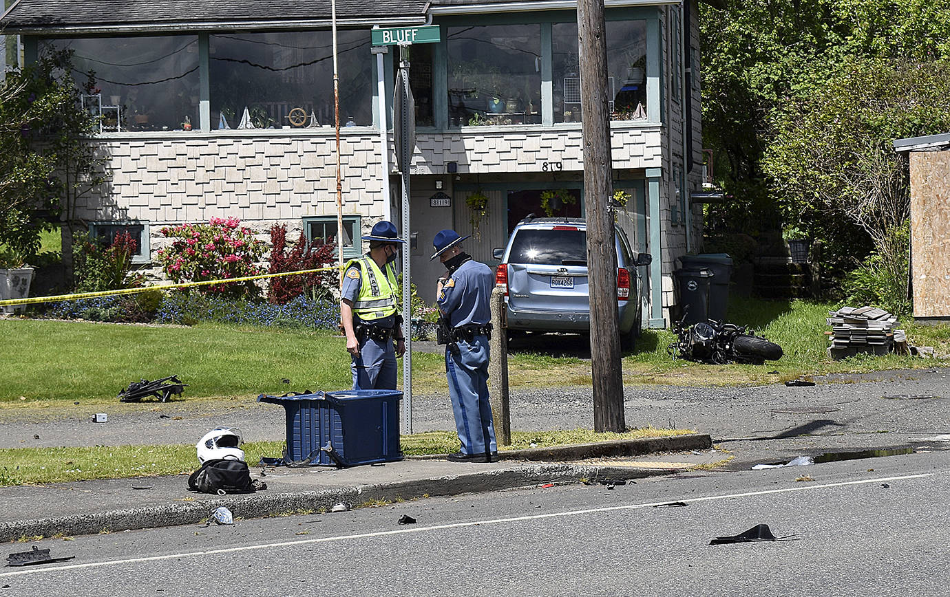 DAN HAMMOCK | THE DAILY WORLD 
State Patrol investigators at the scene of a high-speed motorcycle wreck on Lincoln Street in Hoquiam Tuesday afternoon. The driver, identified as James Cody Stearns, 30, of Hoquiam, was ejected and struck the mailbox at the feet of the trooper, left. The bike is visible to the right of the minivan in the background. Stearns was pronounced dead at the hospital at 1:10 p.m.