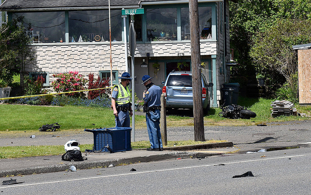 DAN HAMMOCK | THE DAILY WORLD 
State Patrol investigators at the scene of a high-speed motorcycle wreck on Lincoln Street in Hoquiam Tuesday afternoon. The driver, identified as James Cody Stearns, 30, of Hoquiam, was ejected and struck the mailbox at the feet of the trooper, left. The bike is visible to the right of the minivan in the background. Stearns was pronounced dead at the hospital at 1:10 p.m.