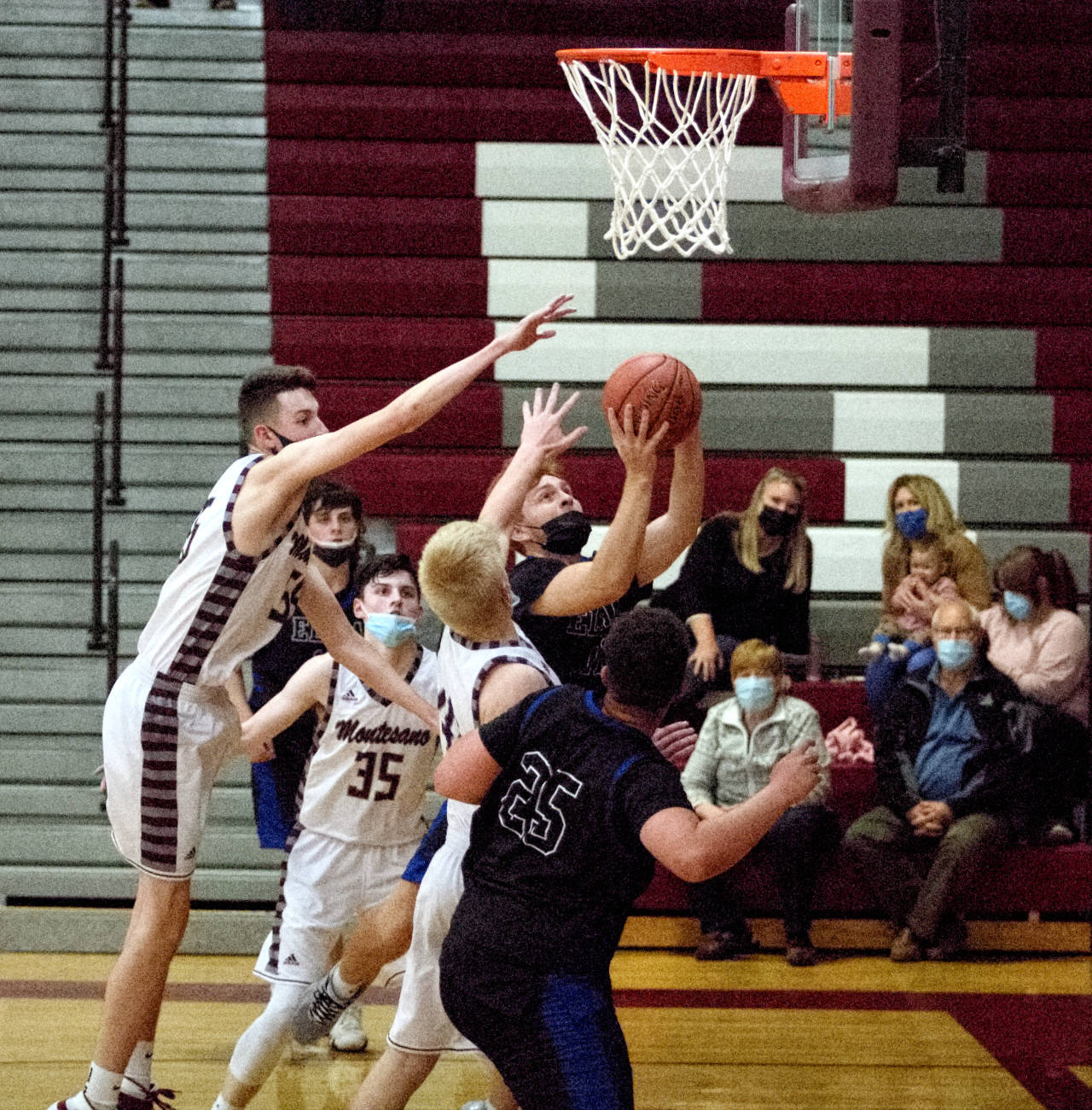 RYAN SPARKS | THE DAILY WORLD Elma’s Nick Church, background, is swarmed by Montesano defenders during Elma’s 55-36 victory on Wednesday at Montesano High School.