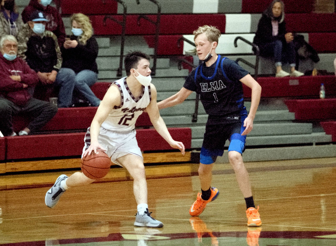 RYAN SPARKS | THE DAILY WORLD Montesano’s Carter Lutz (12) dribbles against Elma’s Carson Seaberg during Elma’s 55-36 victory on Wednesday at Bo Griffith Memorial Gymnasium in Montesano.