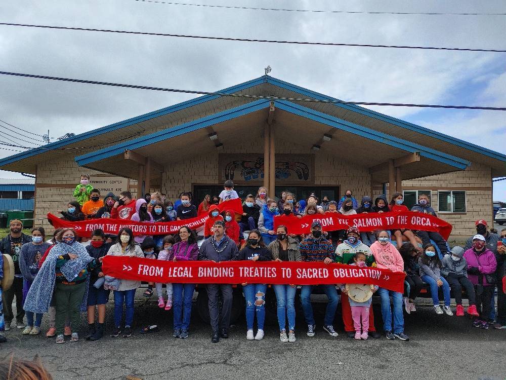 Community members gather in front of the Taholah Community Center on Thursday as students received a special permit to get out of school to witness the event. (Photo provided by April Obi)