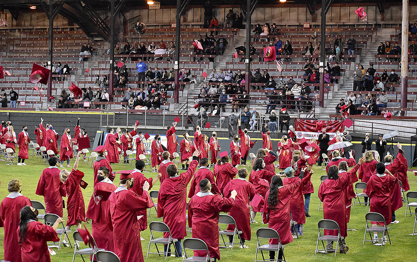 DAN HAMMOCK | THE DAILY WORLD 
Hoquiam High School’s newest class of graduates tosses its mortarboards into the air at the conclusion of the 2021 graduation ceremony at Olympic Stadium Sunday.