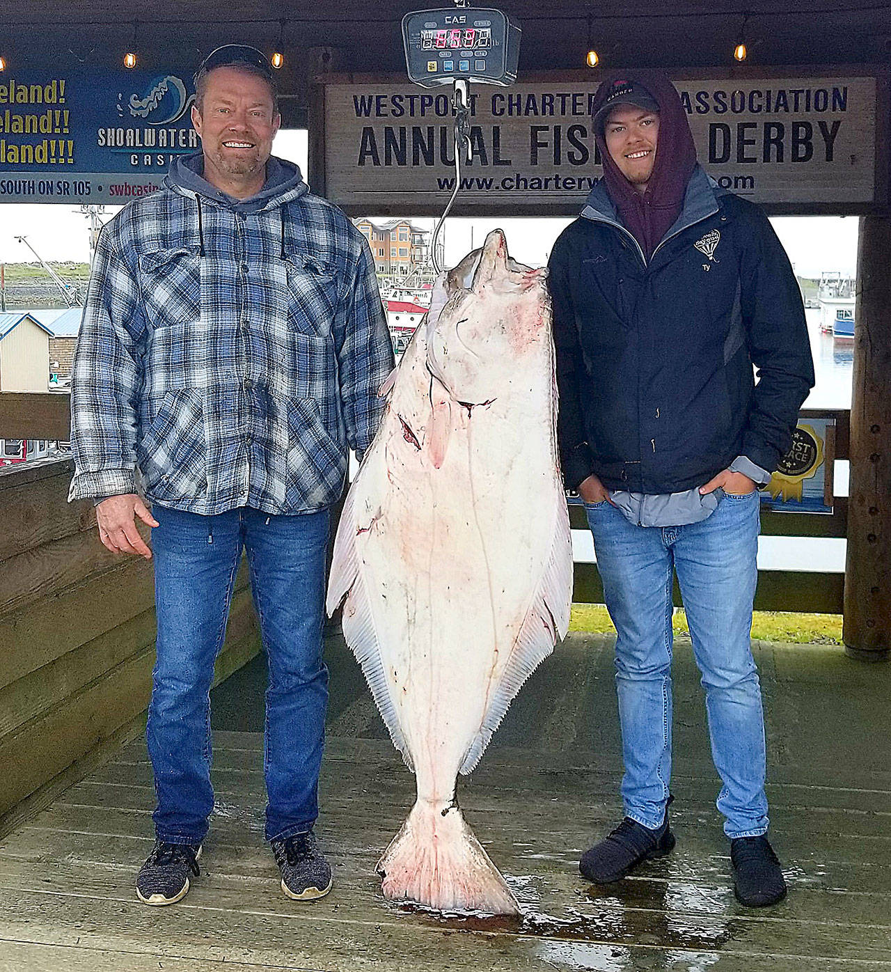 Ty Haskew, pictured with his dad, Pat, from Otis Orchards currently leads the Westport Charter Boat Association halibut derby with this 6.65-pound slab caught above the charter boat High Life May 16. Three more days have been added to the season, June 17, 20 and 24. (Courtesy Westport Weighmaster)