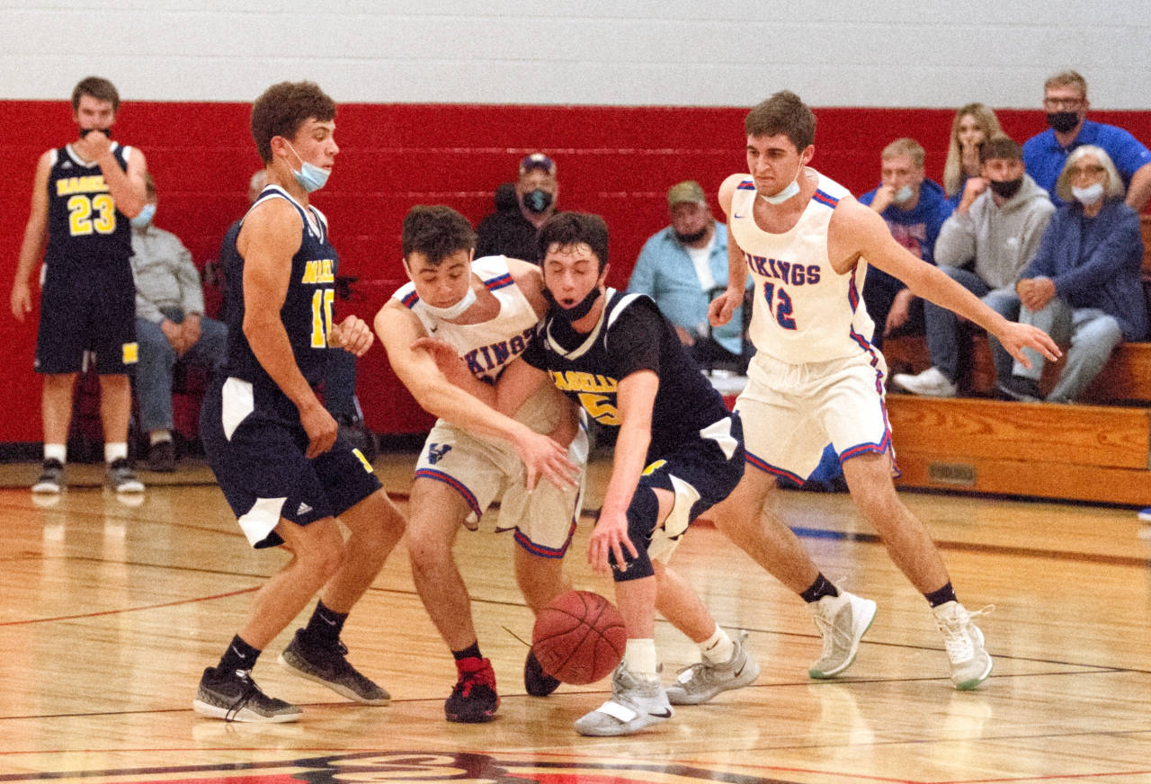 RYAN SPARKS | THE DAILY WORLD Willapa Valley’s Joseph Pulsipher, second from left, fouls Naselle’s Colby Glenn while Willapa Valley’s Gavin Hampton (12) looks on during the Vikings’ 66-51 loss in the 1B District 4 Championship game on Tuesday in Oakville.
