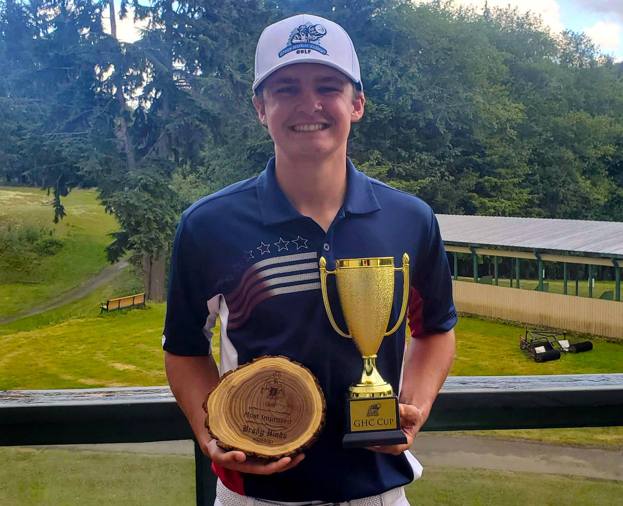 SUBMITTED PHOTO Grays Harbor College’s Brady Hinds holds the GHC Cup after shooting a total of 217 over 54 holes to win the three-round tournament on Saturday.