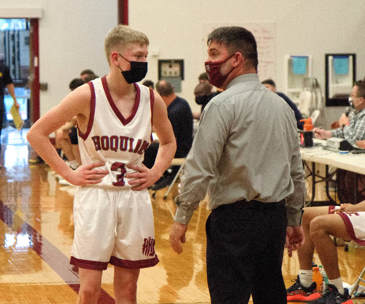 DAILY WORLD FILE PHOTO 1A Evergreen League co-MVP Michael Lorton Watkins, left, and Hoquiam head coach Kyle Blumberg discuss strategy during a game earlier this season. Blumberg was named the league’s top coach in his first year at the helm of the Grizzlies program.