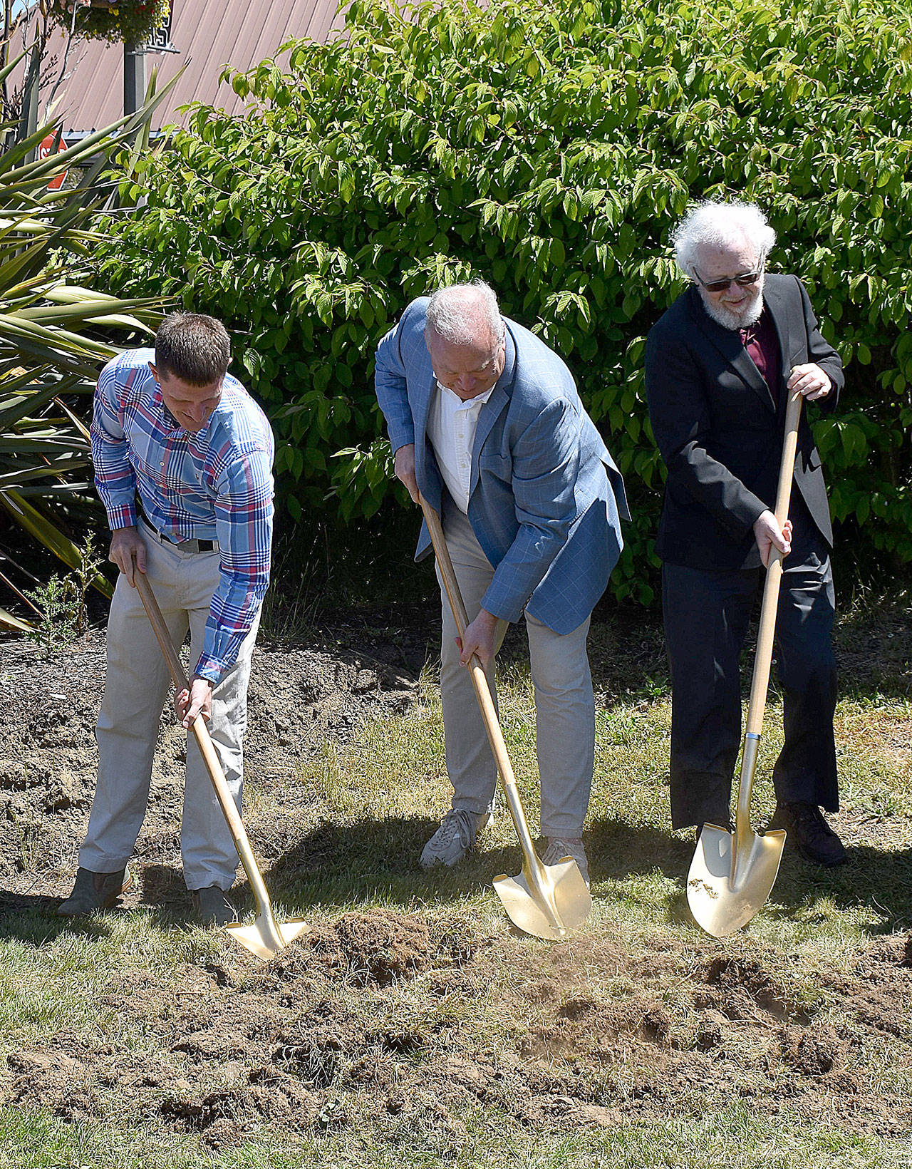 DAN HAMMOCK | THE DAILY WORLD 
From left, 19th District Representatives Joel McEntire and Jim Walsh and Raymond Mayor Tony Nordin use golden shovels to break ground Thursday at the site of the future Willapa Center in Raymond.
