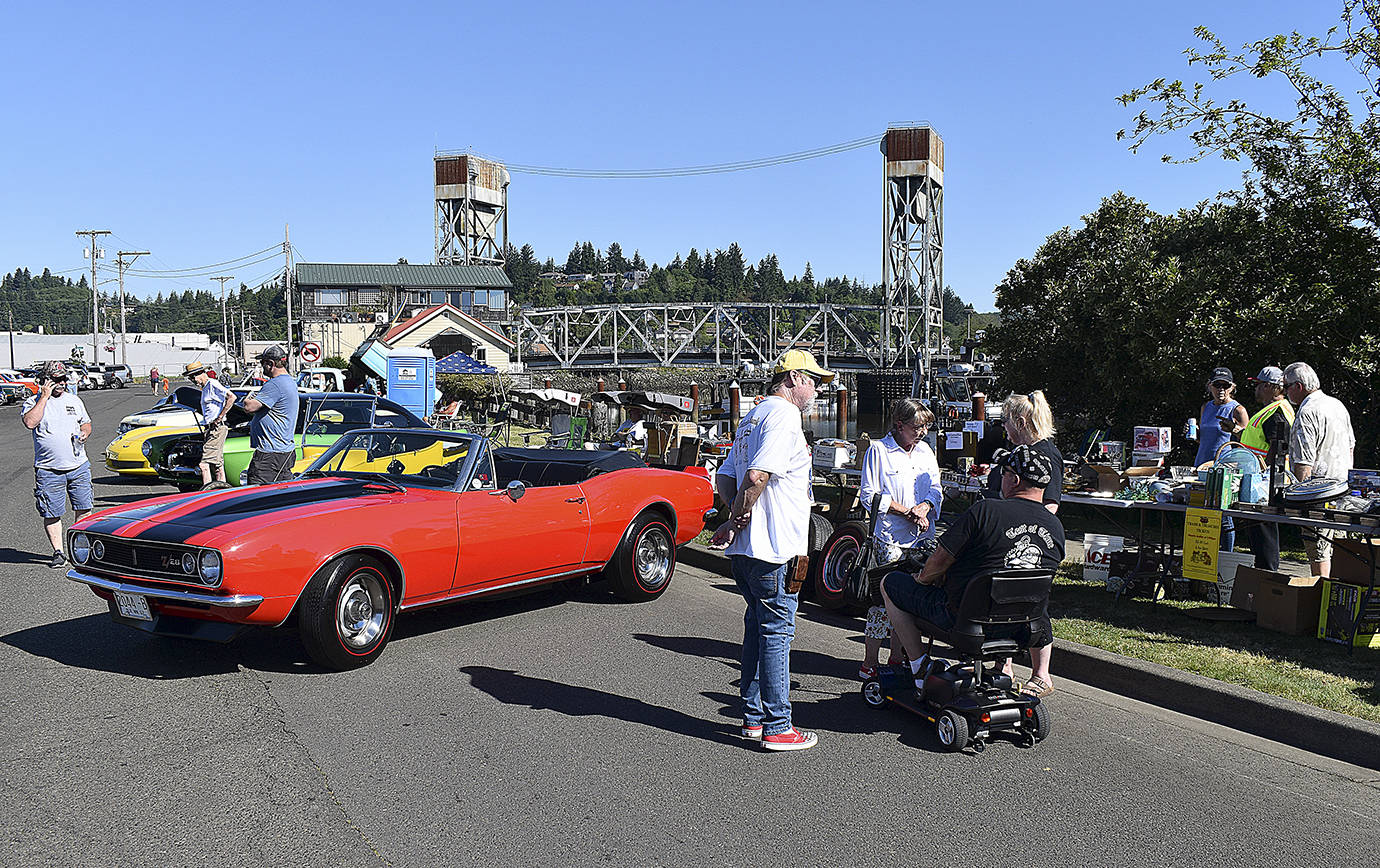 DAN HAMMOCK | THE DAILY WORLD 
Situated between the classic cars and the Hoquiam Pushrods River Run Revival car show registration booth on Levee Street on Saturday was the popular “Trash and Treasure” table with lots of items to be auctioned toward the end of the show.