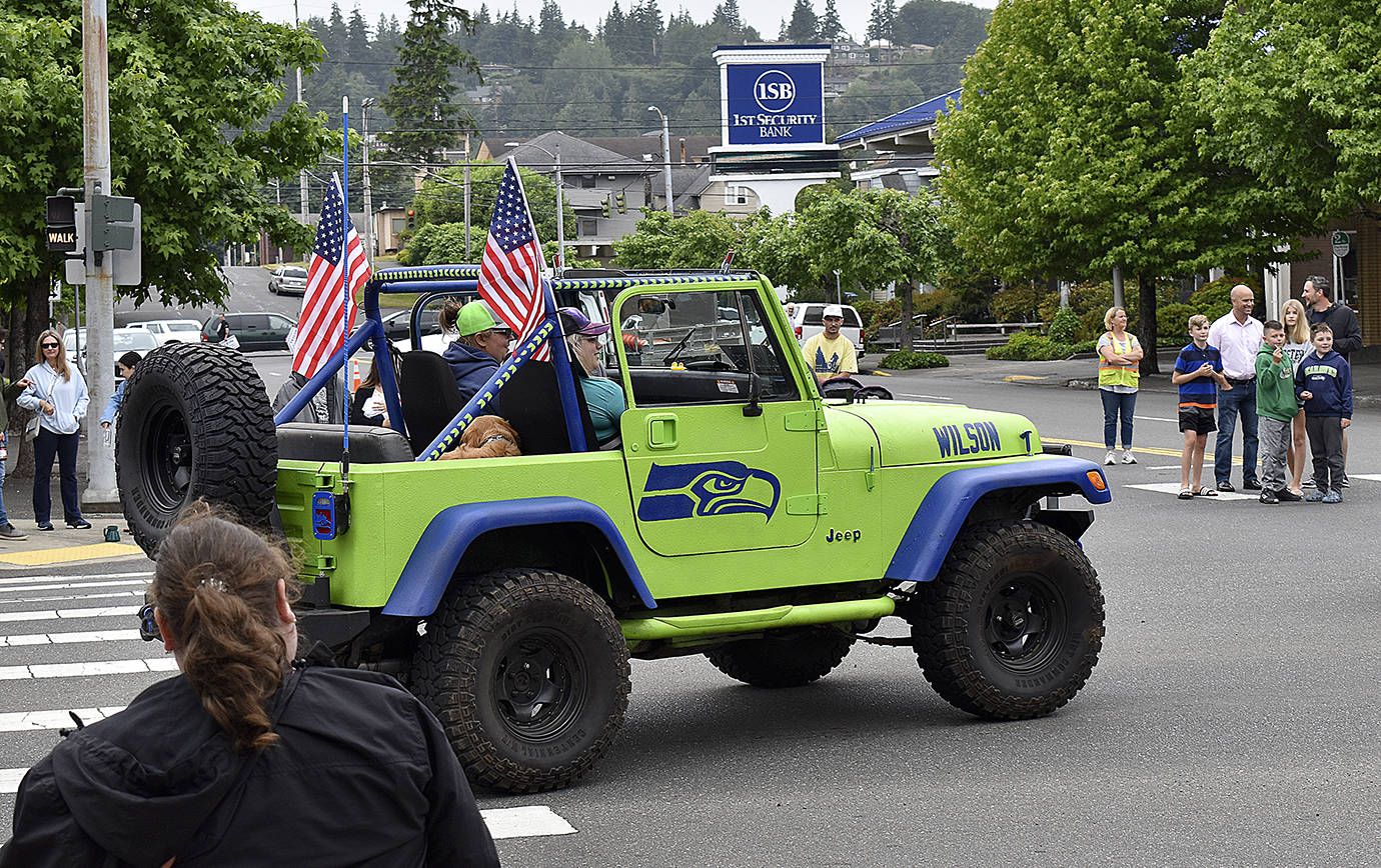 DAN HAMMOCK | THE DAILY WORLD 
The Single Jeepers, a group of single Jeep enthusiasts, had several rigs in the Aberdeen Founders Day parade Saturday, including this one outfitted in Seahawks blue and green.