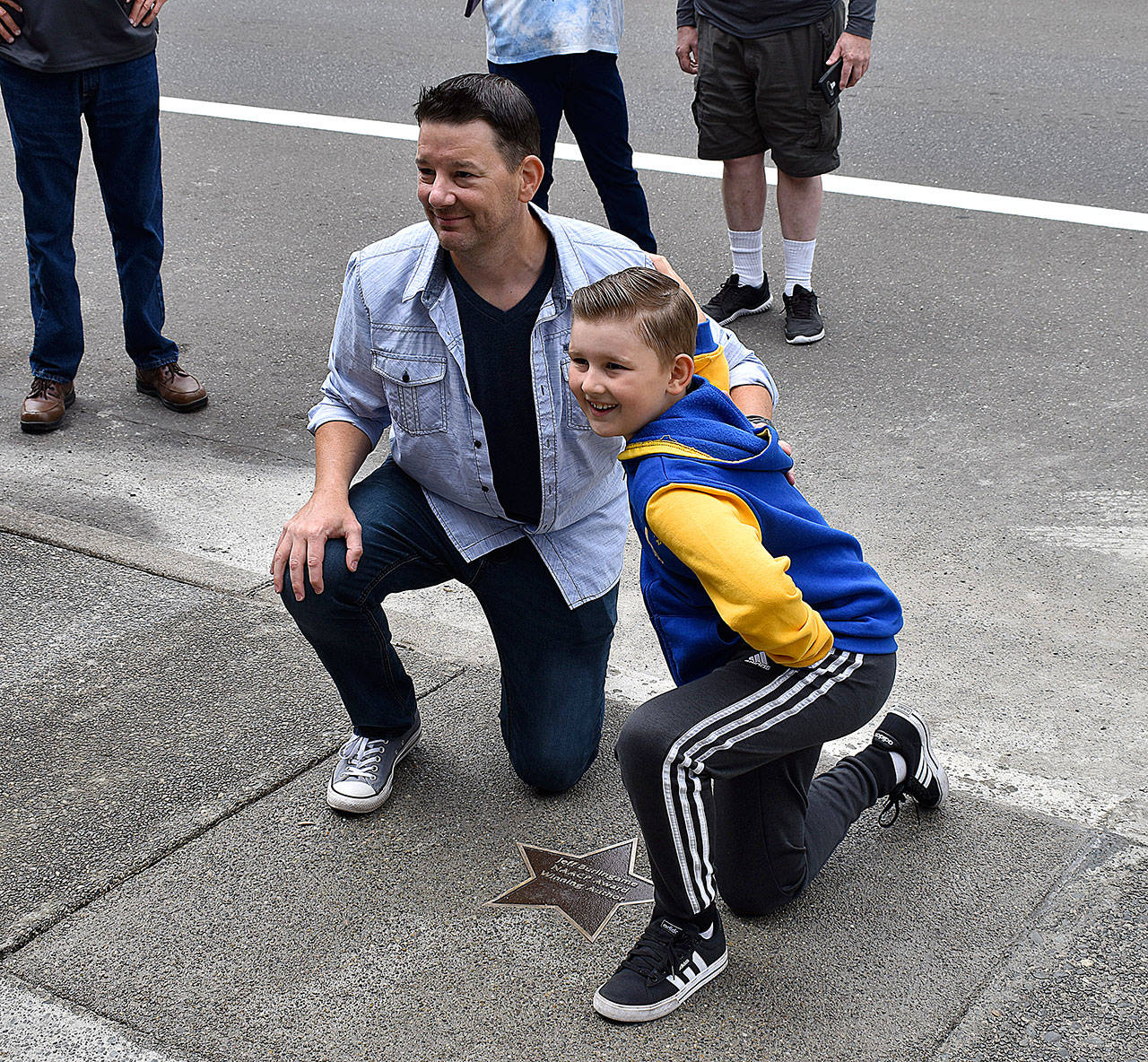 DAN HAMMOCK / THE DAILY WORLD 
Author Jeff Burlingame and his son, Grayson, at the dedication of Burlingame’s star on the Aberdeen Walk of Fame in front of the Aberdeen Timberland Regional Library on Market Street Saturday.
