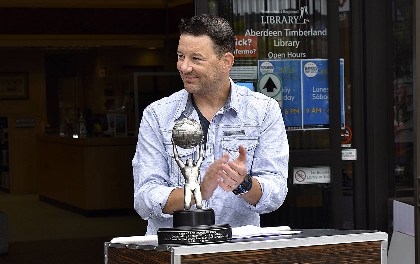 DAN HAMMOCK | THE DAILY WORLD 
Author Jeff Burlingame brought his NAACP Image Award to a ceremony Saturday dedicating a star in his honor on the Aberdeen Walk of Fame.