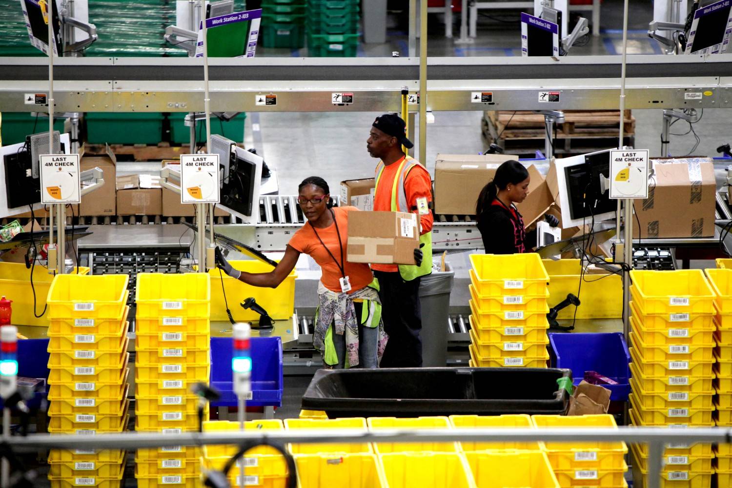 Irfan Khan | Los Angeles Times 
Workers at Amazon’s Fulfillment Center in San Bernardino, Calif.