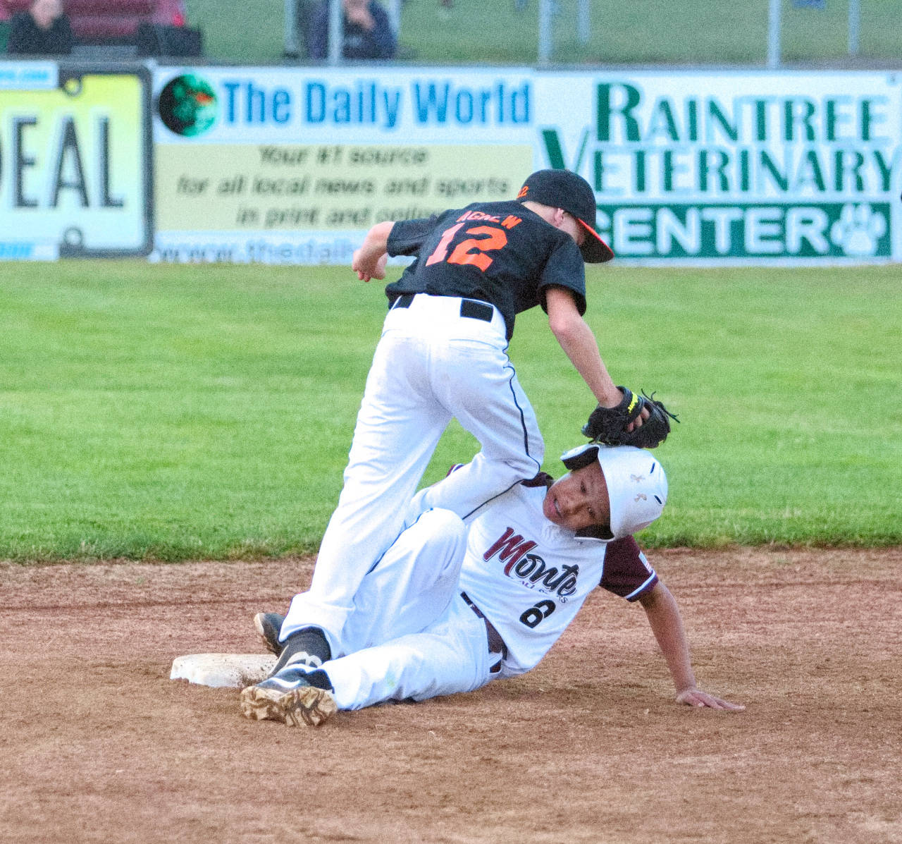 RYAN SPARKS | THE DAILY WORLD 
Montesano shortstop Kevin Dison (8) slides in safely at second base ahead of the tag from Centralia’s Zayne Agnew during Thursday’s elimination game in the 10-12 TOC Tournament at Nelson Field in Montesano. Montesano lost the game 10-9.