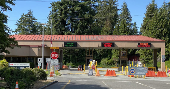 Richard Read | Los Angeles Times, file photo 
Exit lanes from Point Roberts sit empty at the local Canadian border station, which was shut down to all but essential travel during the COVID-19 pandemic.