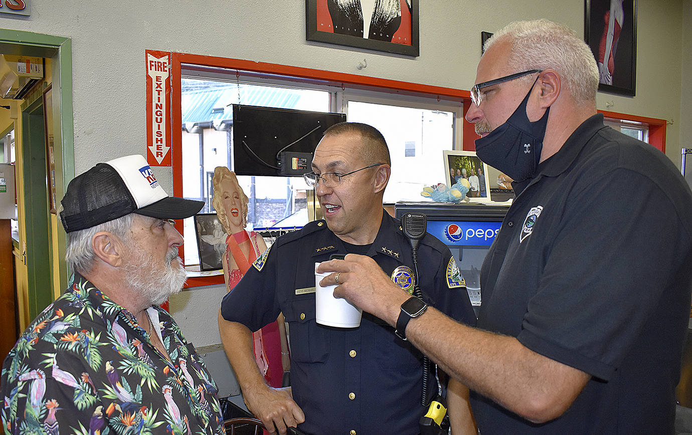 DAN HAMMOCK | THE DAILY WORLD 
Doug McDowell, left, chats with Aberdeen Police Chief Steve Shumate, center, and Hoquiam Police Chief Jeff Myers at McDowell’s final KBKW broadcast at the Hoquiam Farmer’s Market Tuesday morning.