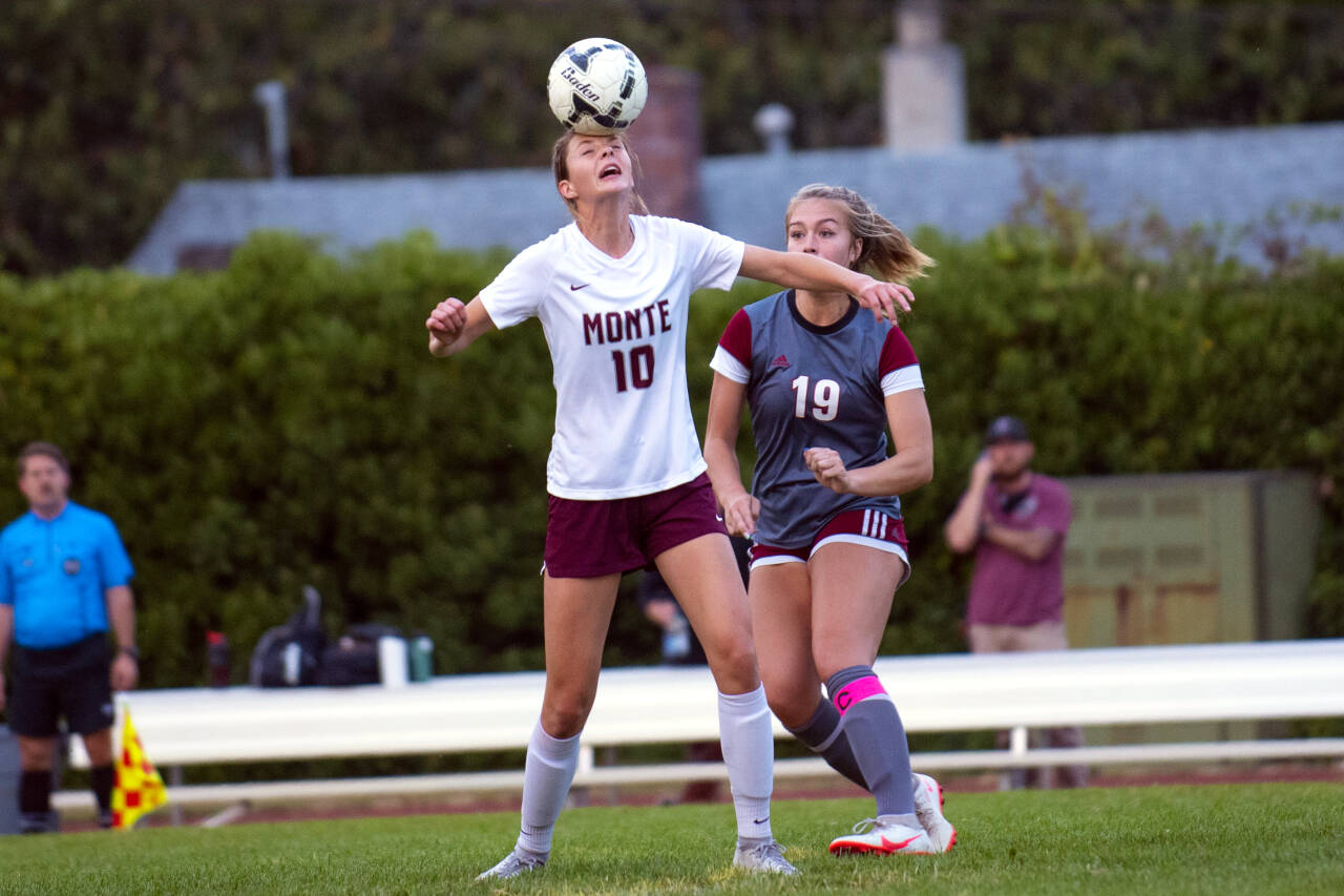 ERIC TRENT | THE CHRONICLE Montesano’s Mikayla Stanfield (10) heads the ball in front of WF West’s Kyla McCallum during the Bulldogs’ 2-1 victory on Tuesday in Chehalis.