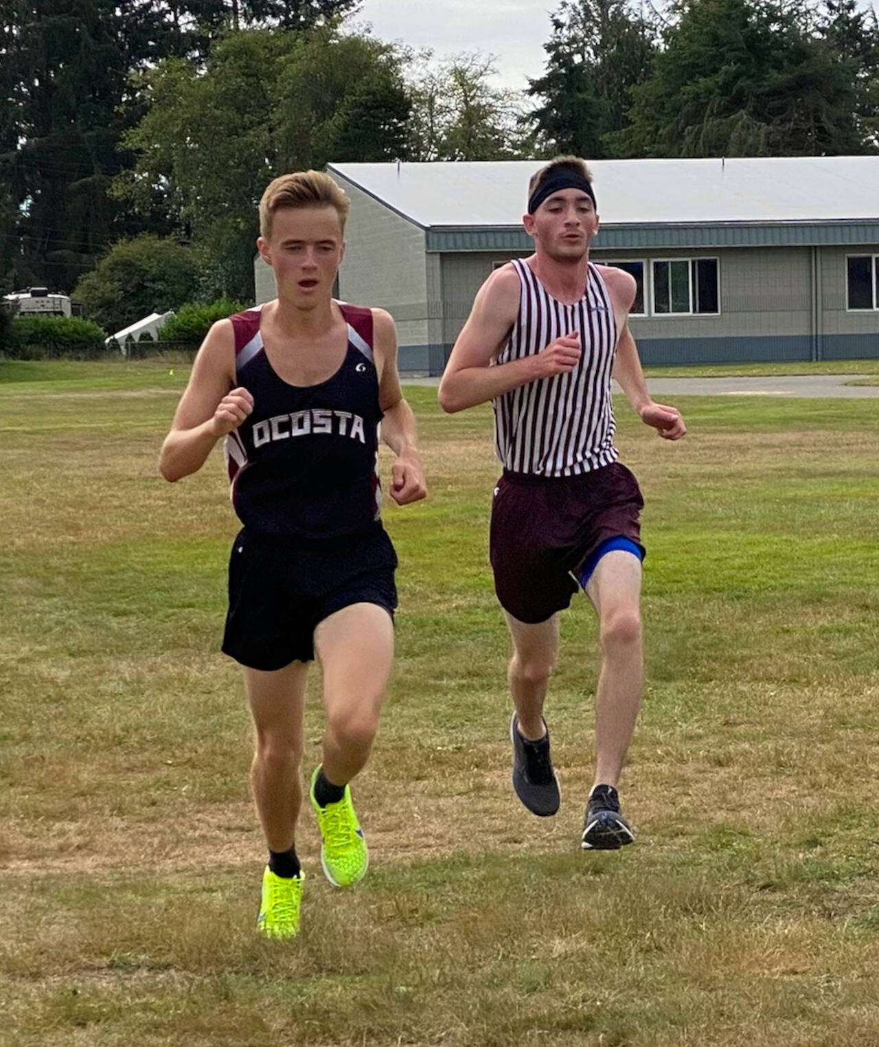 SUBMITTED PHOTO Ocosta’s Dylan Todd, left, and Montesano’s Aric Jacklin crossed the finish line 1-2, respectively, at the Ocosta Invitational cross country meet on Saturday in Westport.