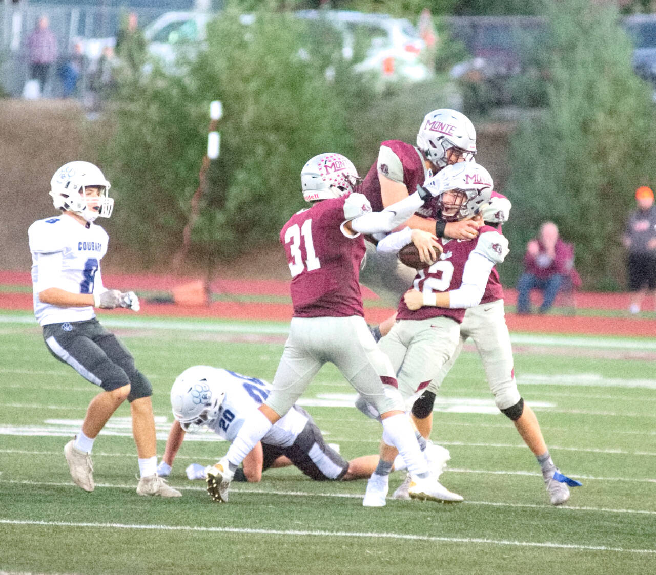 RYAN SPARKS | THE DAILY WORLD 
Montesano’s Cole Ekerson (12) is surrounded by teammates after coming up with an interception against Cascade Christian last week. The Bulldogs take on Columbia-White Salmon on Thursday.
