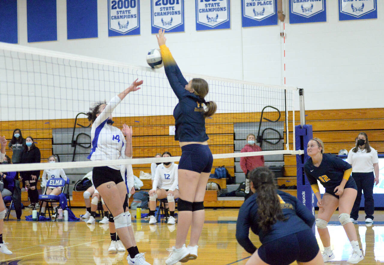 RYAN SPARKS | THE DAILY WORLD Aberdeen middle blocker Lilly Camp, center, blocks the attempt of Elma middle hitter Torrey Thompson during the Bobcats’ 3-1 victory on Thursday in Elma.
