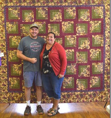 Photo by Vivian Edersheim 
The 2021 quilt raffled by the Willapa Harbor Quilters has found a new home with winner Heather Umstead-Hines, shown with her husband, Jonathan Hines. The couple live in Vancouver, but are in the process of building a cabin in Bay Center. Their ticket was drawn at the end of the Pacific County Fair on Aug. 28, 2021. Proceeds from the raffle go toward the Willapa Harbor Quilters’ project of making patriotic quilts for Pacific County veterans. To date, more than 200 quilts have been presented to local veterans.