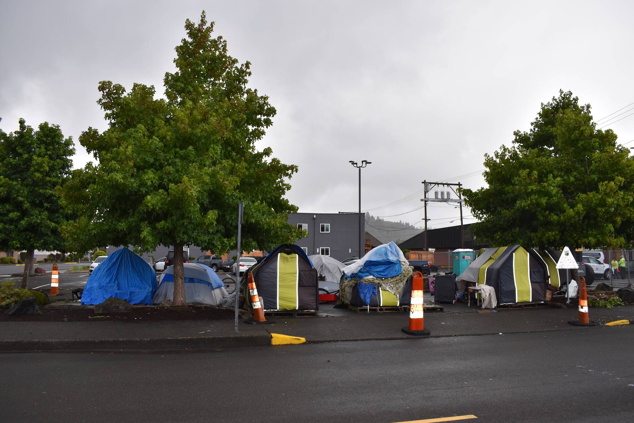 DAN HAMMOCK | THE DAILY WORLD The officially-closed TASL homeless tent camp in a parking lot at Aberdeen City Hall has grown to hold about 20 people in the last month, and the city has little legal authority to clear it.