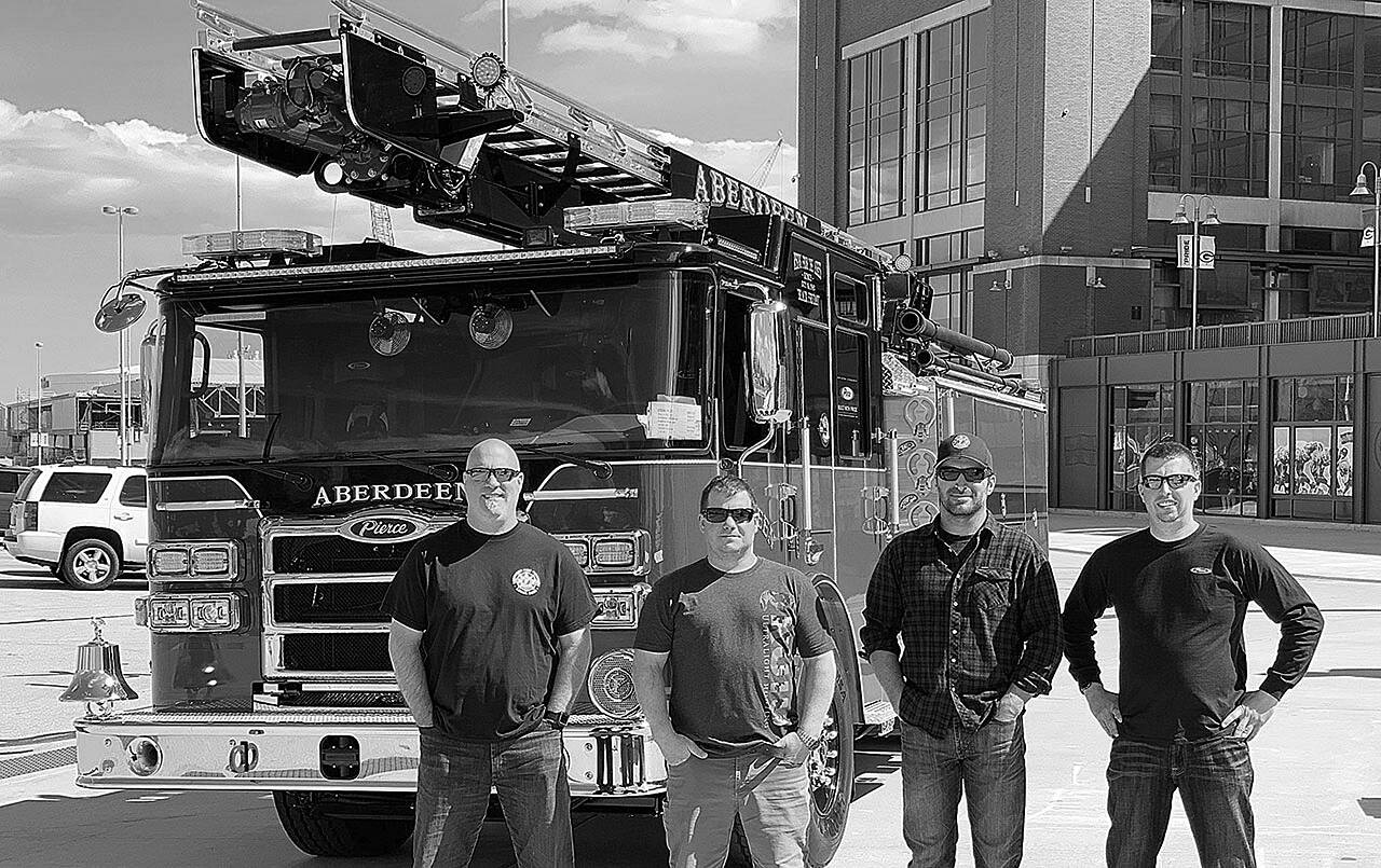 photo by hughes fire equipment inc. | FILE
Aberdeen Fire Department personnel stand next to a new pumper truck and skyboom in May 2020. Pictured from left are firefighter Brian Peterson, Capt. Mike Kolodzie, Capt. Sam Baretich and Engineer Brad Frafjord.