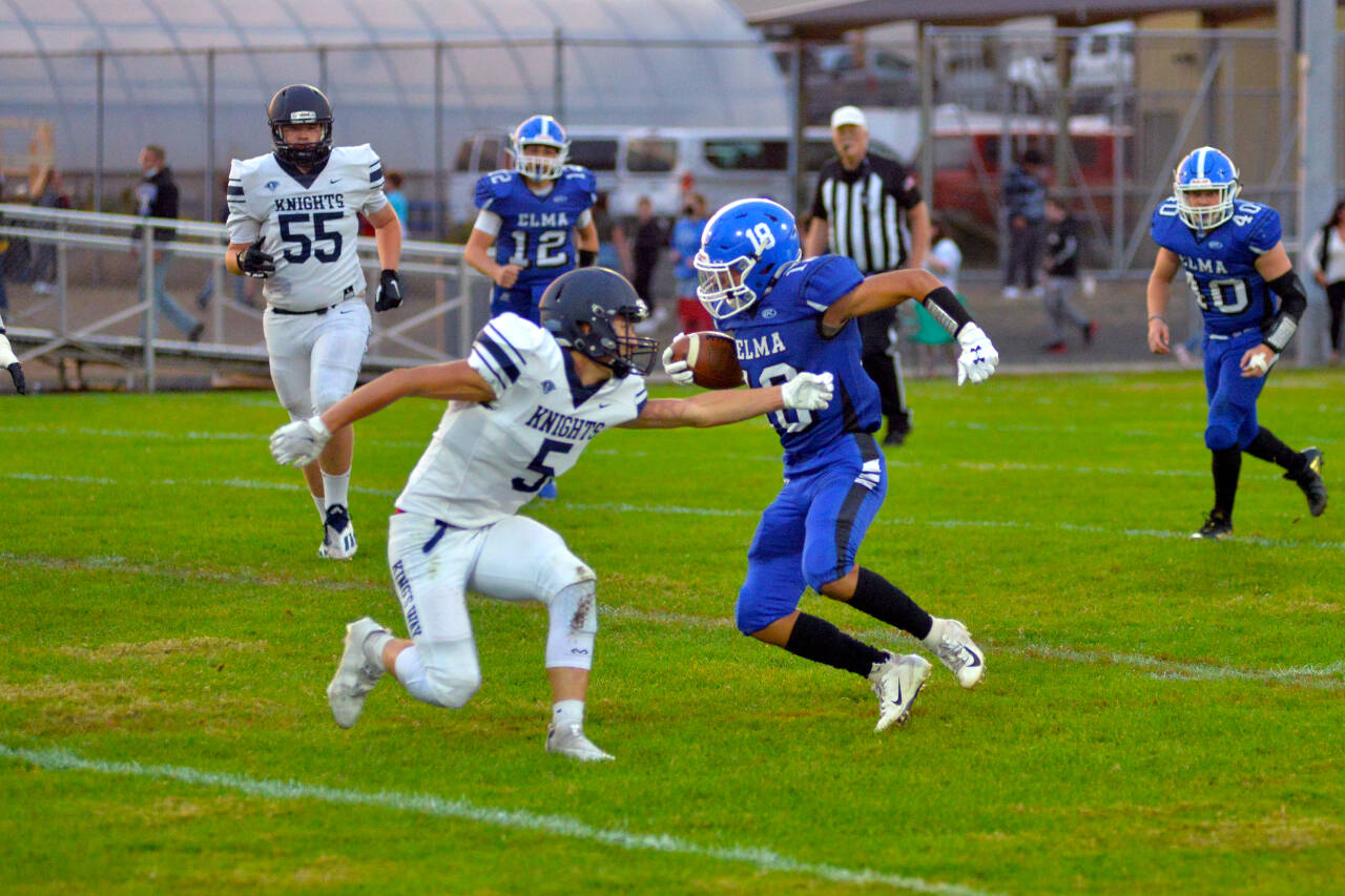 RYAN SPARKS | THE DAILY WORLD Elma receiver René Duran (18) avoids the tackle of King’s Way Christian defender Matthew Belefski during the Eagles’ 66-25 victory on Friday in Elma.