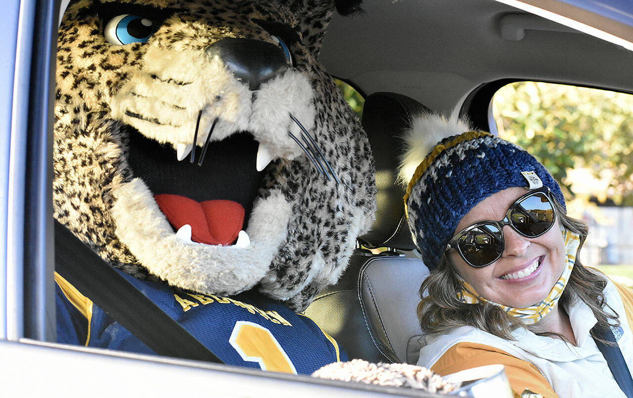 The Aberdeen High School Bobcat Mascot and Aberdeen High School ASB Advisor Ashley Kohlmeier in last year’s Foodball kickoff parade. Hoquiam and Aberdeen high schools will team up for the second year in a row to collect food and money for area food banks starting Oct. 29. (File photo)