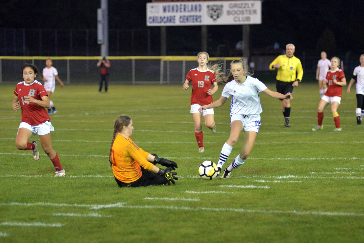 RYAN SPARKS | THE DAILY WORLD Elma forward Beta Valentine (12) tries to get past Hoquiam goal keeper Katie Burnett during Elma’s 7-0 victory on Thursday at Olympic Stadium in Hoquiam. Valentine scored three goals to lead the Eagles.