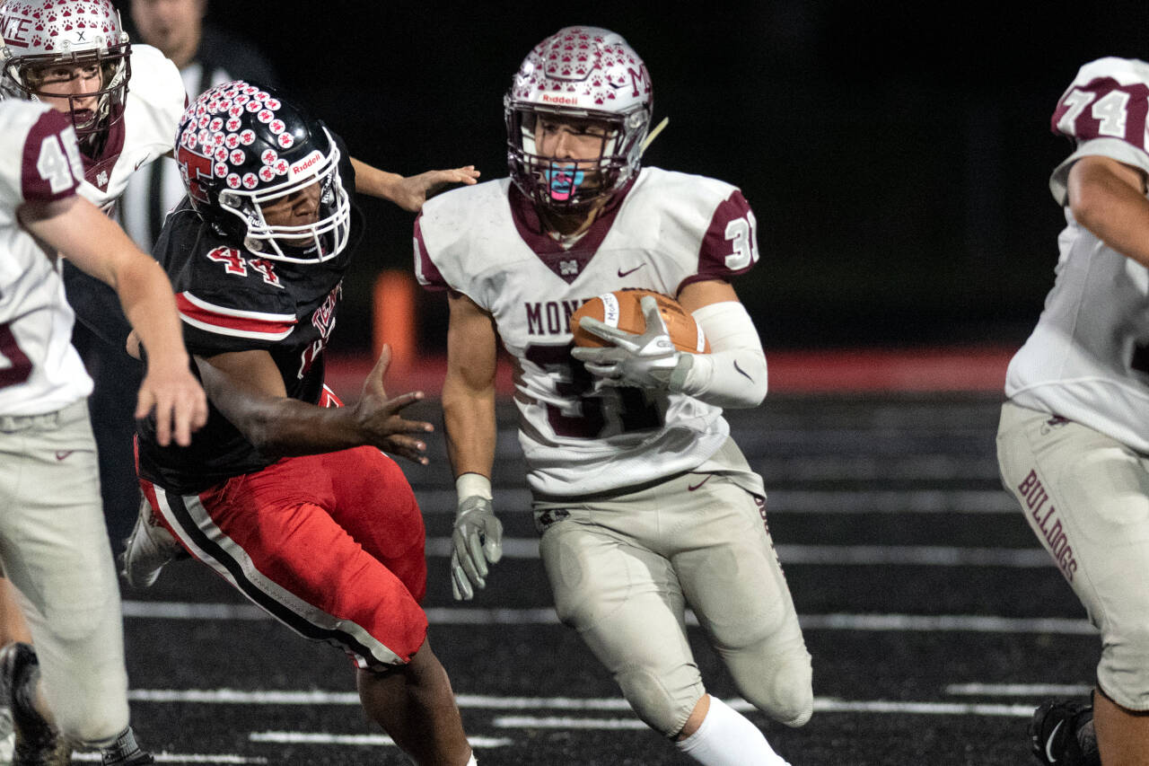Alec Dietz | The Chronicle Montesano running back Isaiah Pierce cuts through Takari Hickle (44) and the Tenino defense on Friday in Tenino. Pierce rushed for over 100 yards in the Bulldogs’ 32-26 loss.