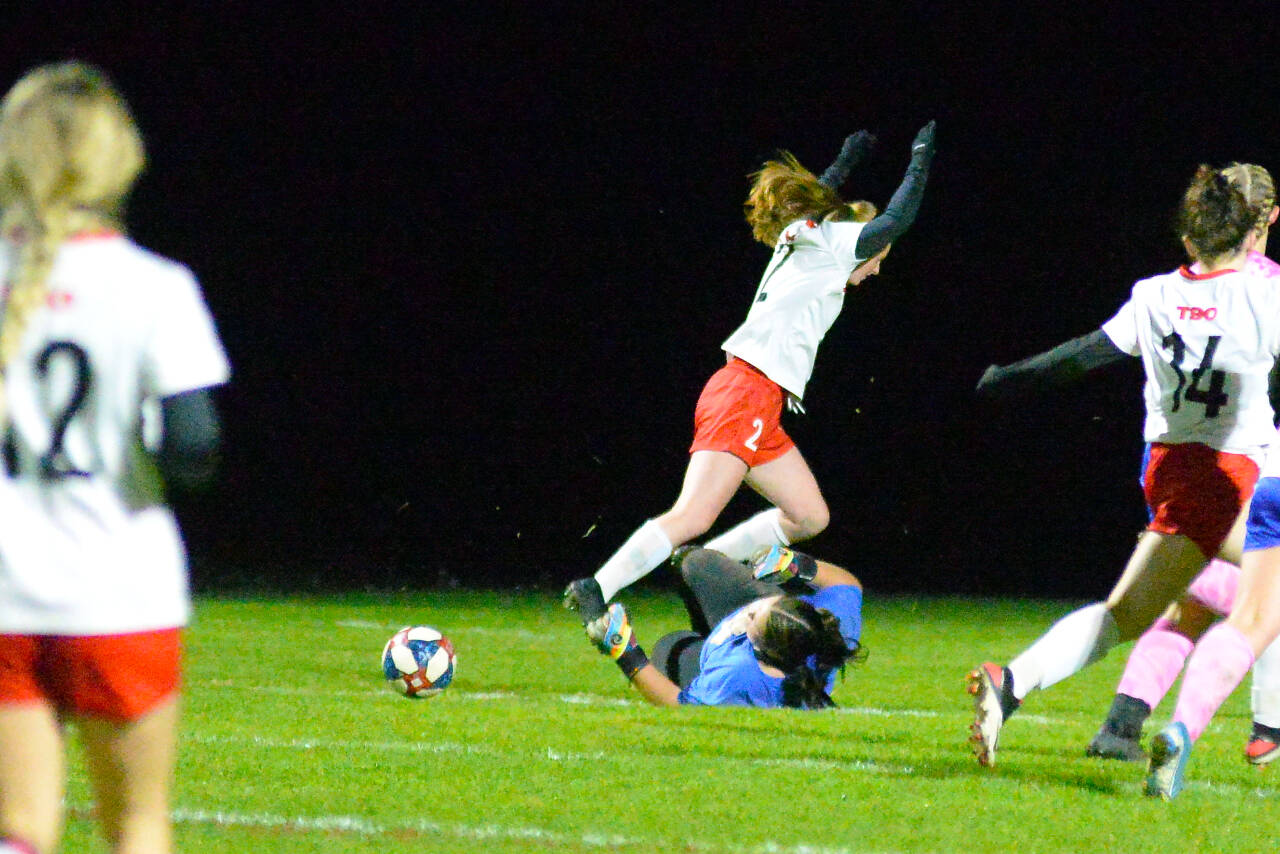 RYAN SPARKS | THE DAILY WORLD Elma goal keeper Grace Koonrad dives to make a save against charging Tenino forward Abby Severse during Elma’s 2-1 victory on Tuesday at Davis Field in Elma.
