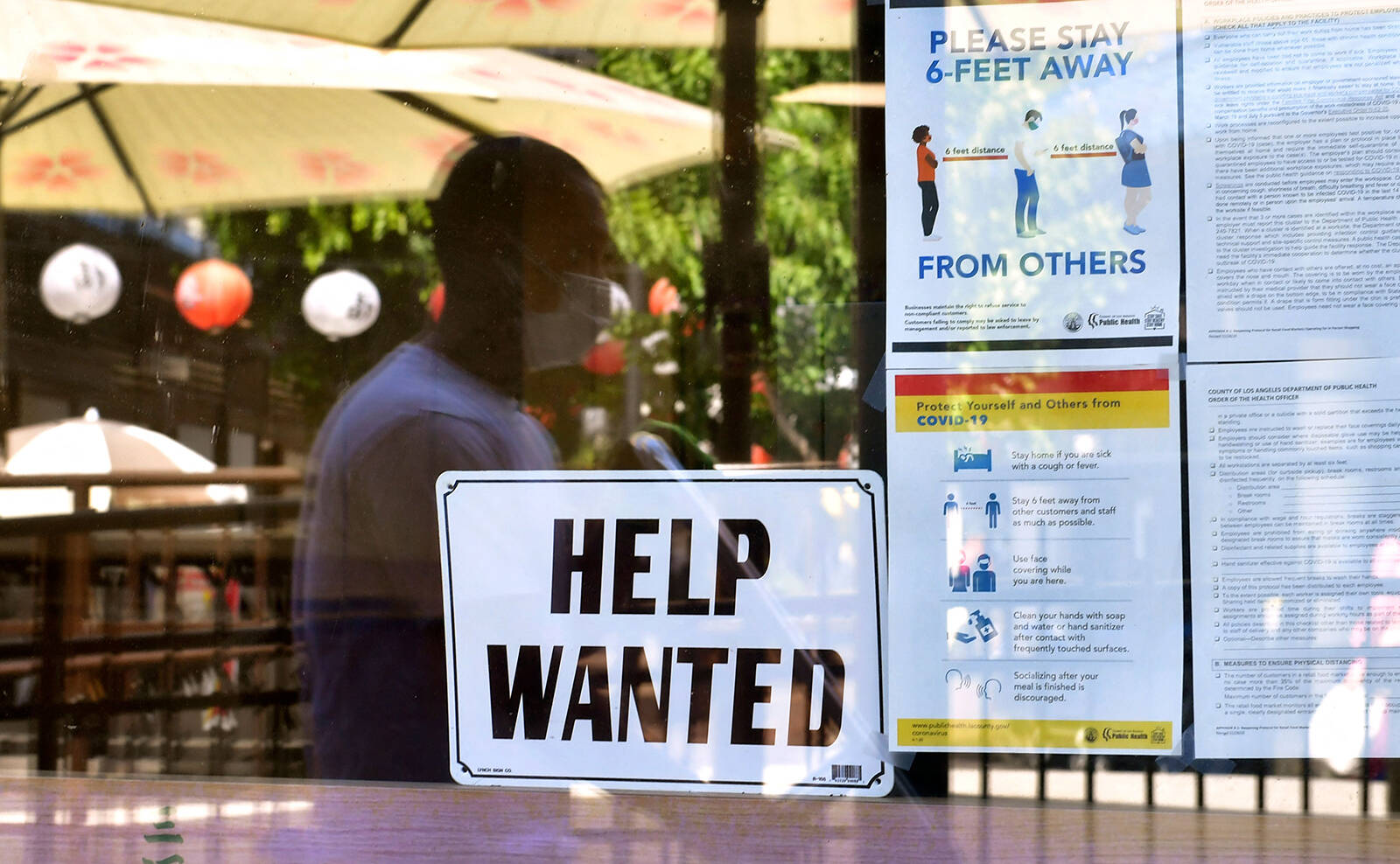 Frederic J. Brown | AFP | Getty Images
A “Help Wanted” sign is posted beside coronavirus safety guidelines in front of a restaurant in Los Angeles on May 28, 2021.