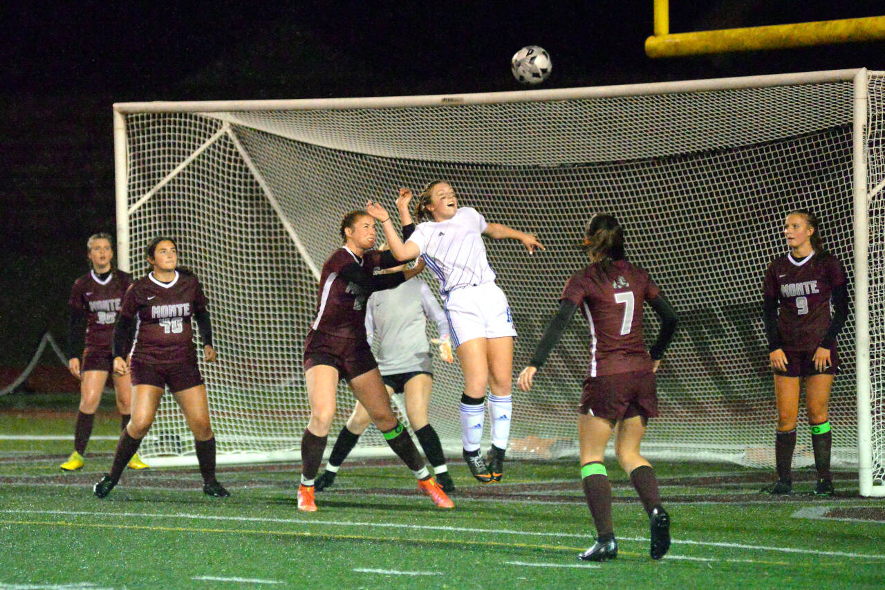 RYAN SPARKS | THE DAILY WORLD Elma’s Grace Spencer leaps for a header on a corner kick while defended by Montesano’s Paige Lisherness during the Bulldogs’ 1-0 win on Thursday at Jack Rottle Field in Montesano.