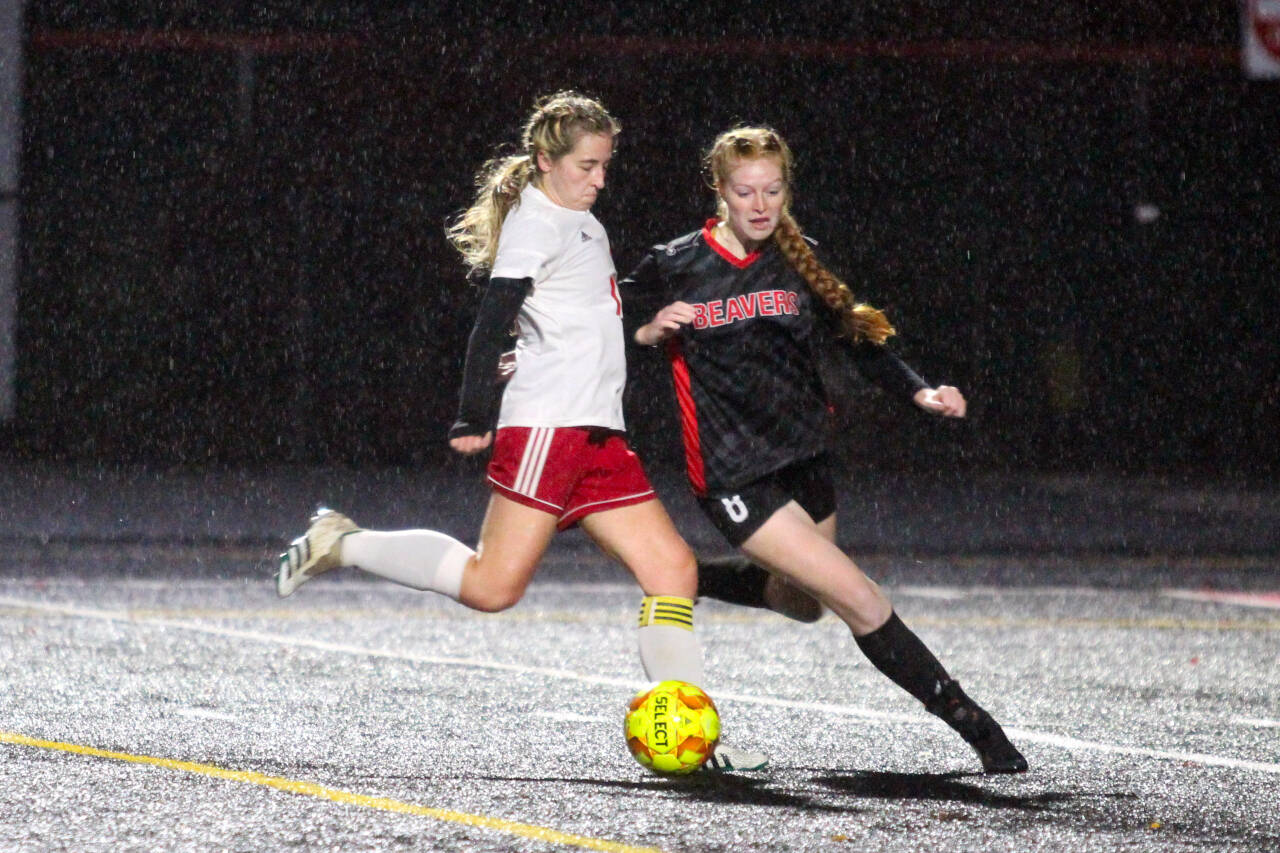 PHOTO BY BEN WINKELMAN Hoquiam midfielder Emma Johnson shoots while being defended by Tenino’s Andee Schaffran during the Grizzlies 2-1 loss on Tuesday in Tenino.