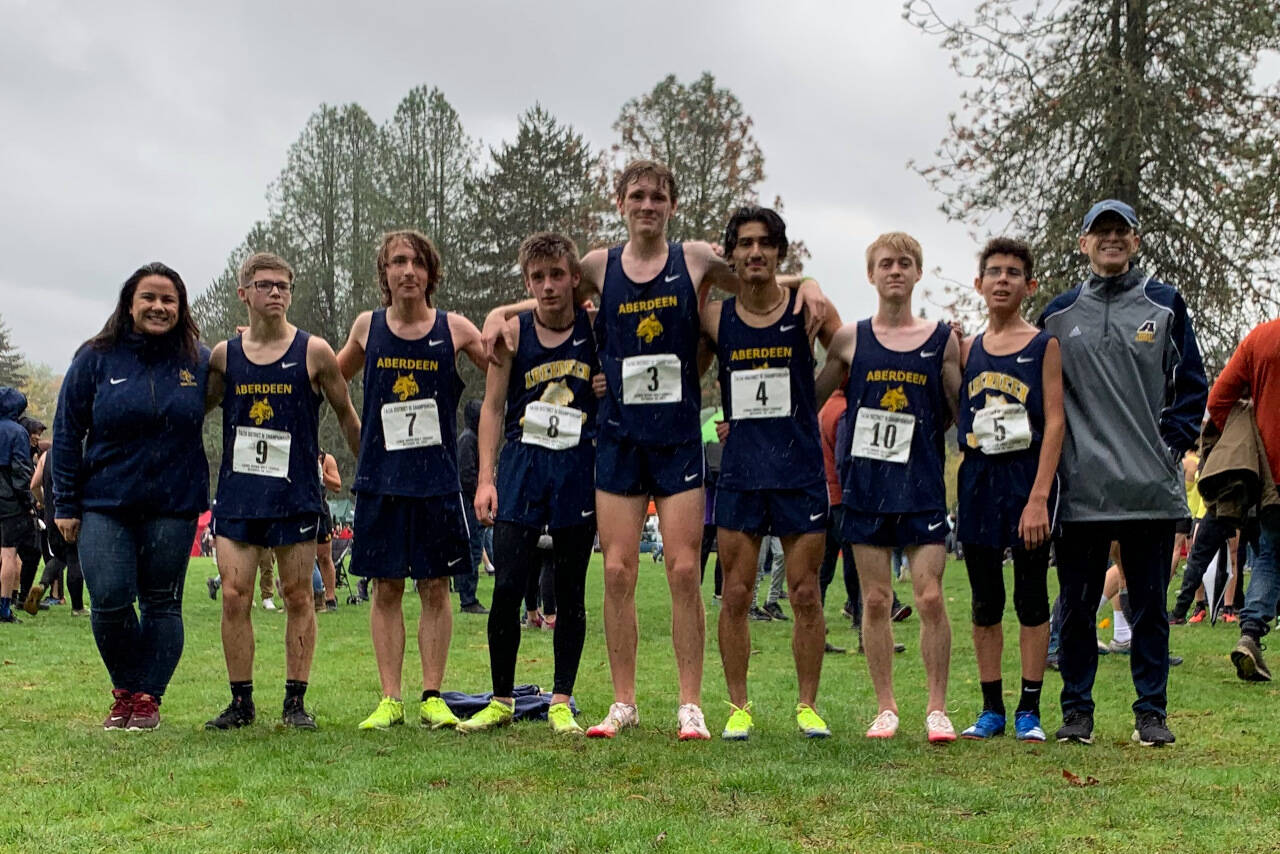 SUBMITTED PHOTO The Aberdeen boys cross country team of (from left) assistant coach Ivy Lyles, Joel Nelson (9), Nolan Juransin (7), Henry Nelson (8), Will Boling (3), Julian Campos (4), Gary Sherman (10), Jacob Hallak (5) and head coach Steve Reed competed at the 2A/1A District 4 Championship meet on Thursday at the Lewis River Golf Course in Woodland. Boling, Campos and Sherman advanced to the state title meet in Pasco on Nov. 6.