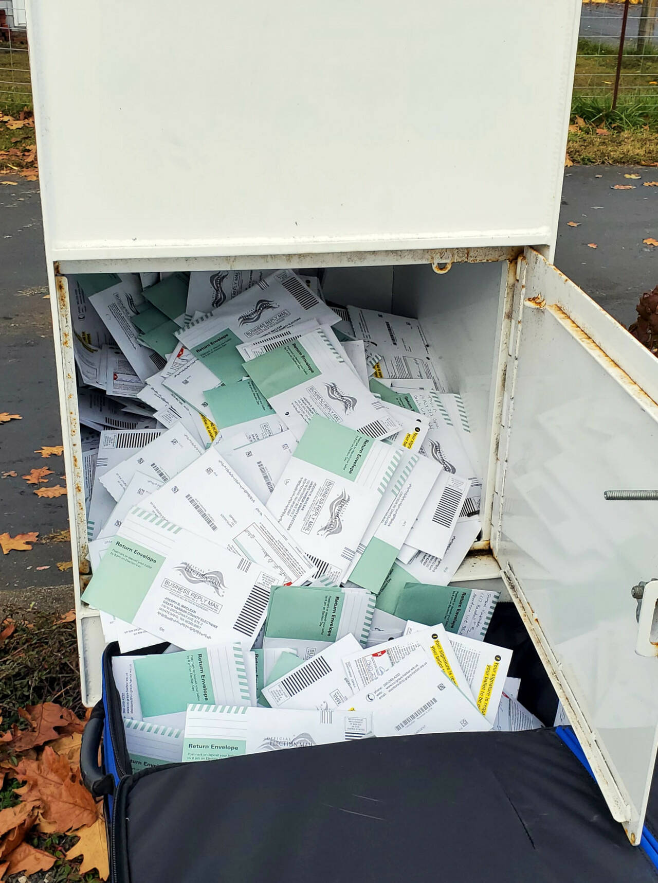 Ballots are taken from a Hoquiam ballot drop box. (File photo)