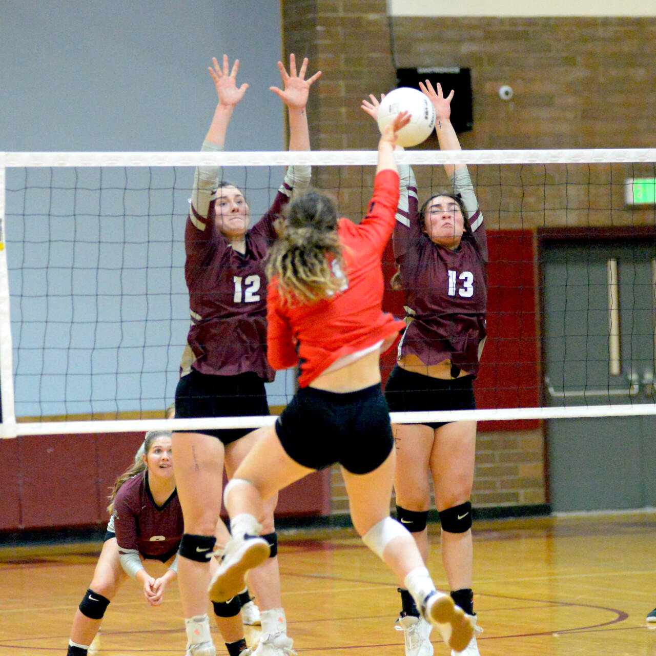 RYAN SPARKS | THE DAILY WORLD Montesano’s McKynnlie Dalan (12) and Addie Winter (13) attempt to block the shot of King’s Way Christian’s Ellie Mathison during a five-set loss in the 1A District 4 Tournament on Wednesday in Montesano.