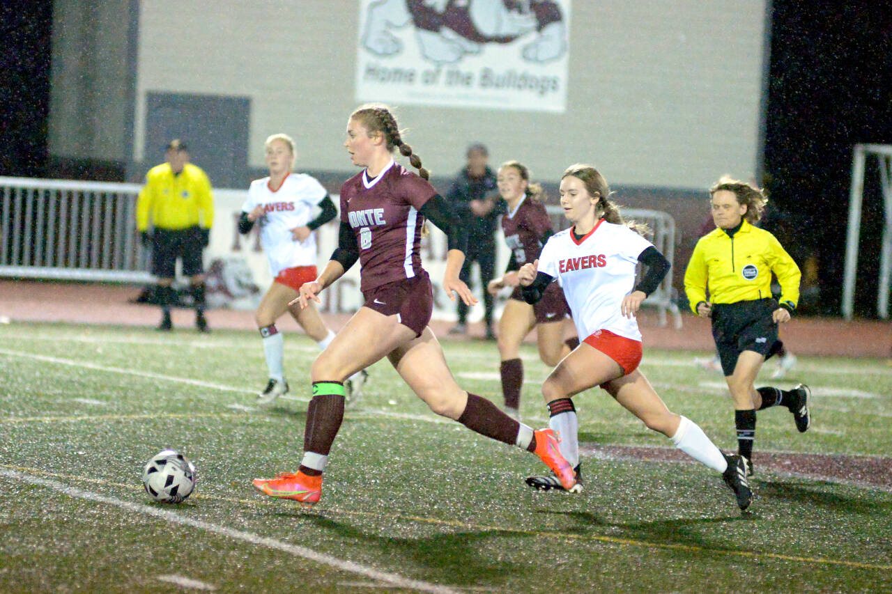 RYAN SPARKS | THE DAILY WORLD Montesano midfielder Paige Lisherness (8) looks to pass upfield while chased by Tenino’s Grace Vestal during the Bulldogs 4-0 victory in the 1A District 4 semifinals on Thursday in Montesano. Monte will face La Center in the district-championship game on Saturday.