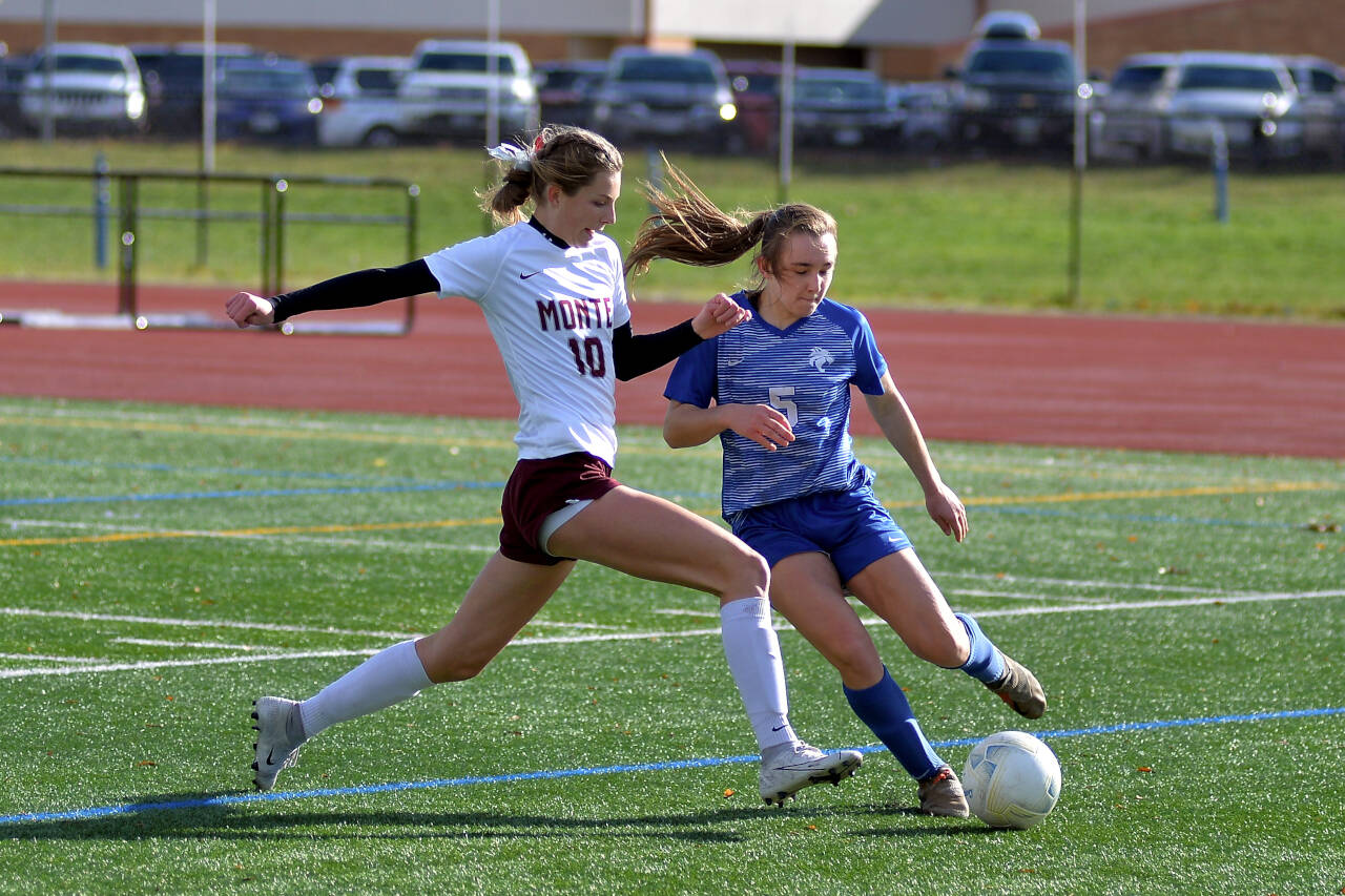 RYAN SPARKS | THE DAILY WORLD Montesano’s Mikayla Stanfield (10) and La Center’s Shaela Bradley battle for possession during Montesano’s 2-1 loss in the championship game of the 1A District 4 Tournament Saturday in Vancouver.