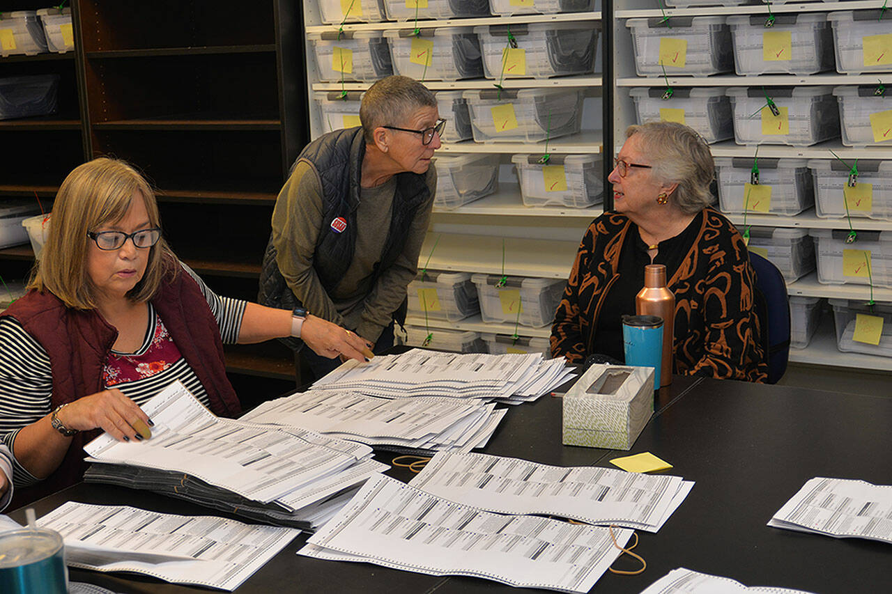 Challenger Susan Conniry (middle) confers with incumbent Crystal Dingler (right) while election worker Kathye Lano (left) sorts the ballots in 2019’s Ocean Shores mayoral race hand count. Dingler won a third term by three votes. (File photo)