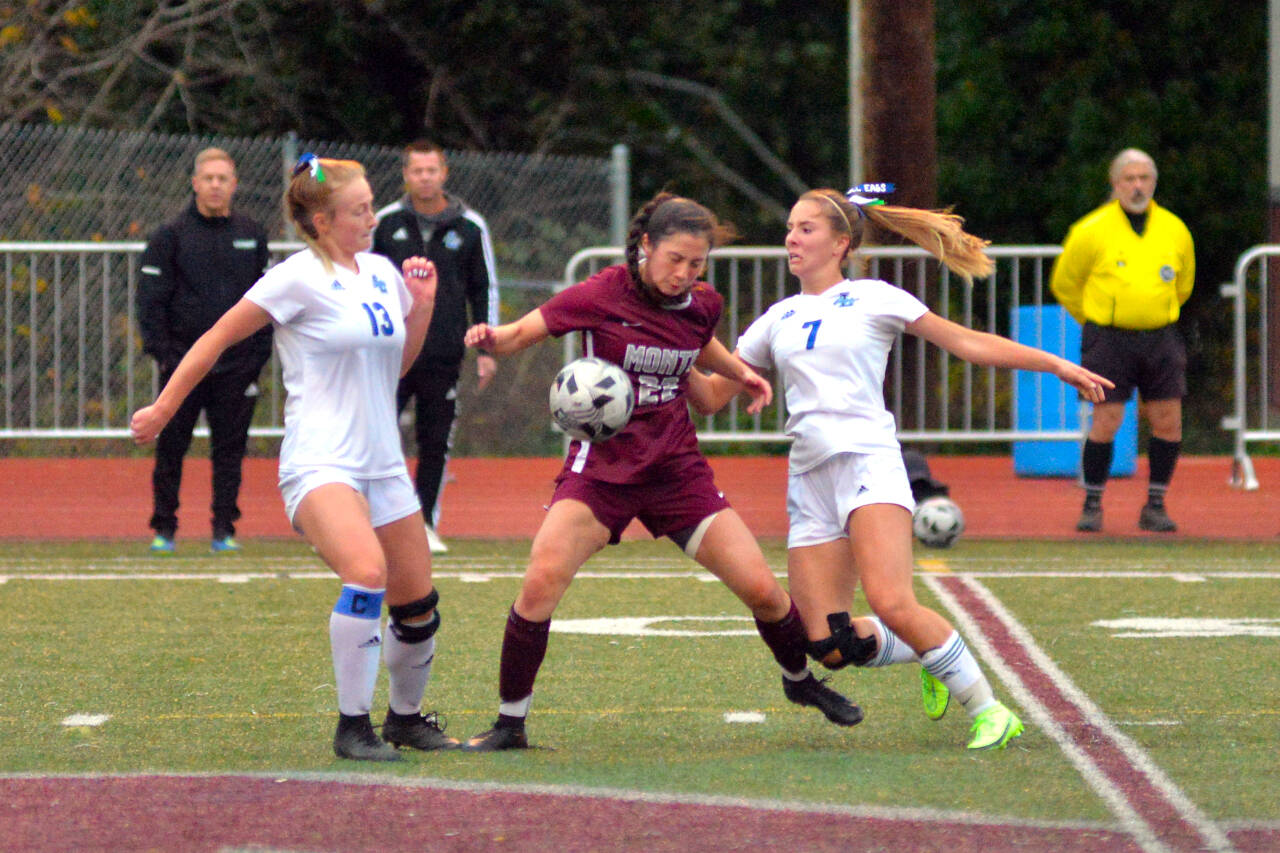 RYAN SPARKS | THE DAILY WORLD Montesano midfielder Bethanie Henderson (22) is sandwiched between Lakeside-Nine Mile Falls’ Hayden Rickey (13) and Ayanna Tobeck during the first half of Montesano 3-1 win in a 1A State Girls Soccer Tournament game on Wednesday in Montesano.