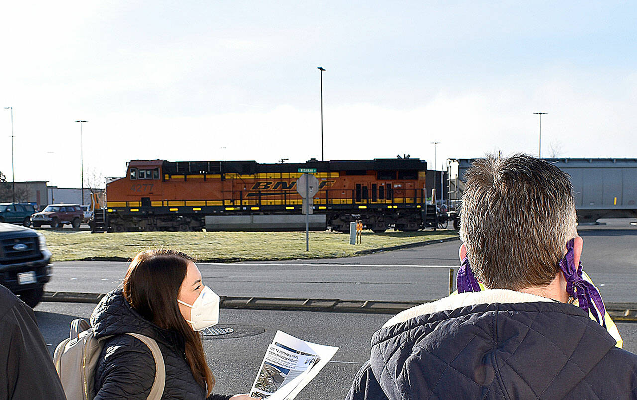 DAN HAMMOCK | THE DAILY WORLD 
A train cuts east through East Aberdeen during a field trip taken by state and local officials to discuss the importance of a project to separate rail and vehicle traffic through the commercially-critical part of the city.