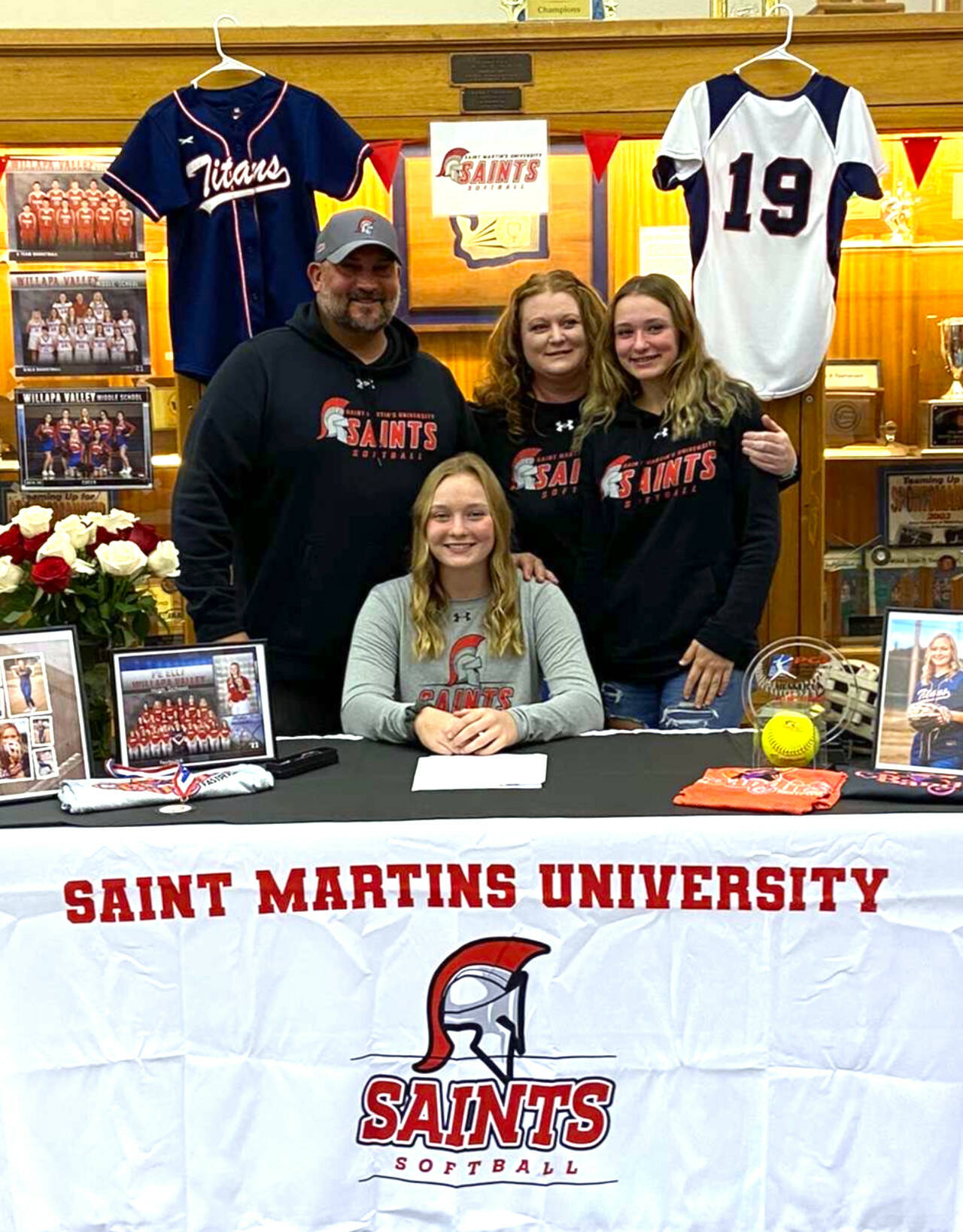 SUBMITTED PHOTO Pe Ell-Willapa Valley standout pitcher Olivia Matlock, seated, signed a National Letter of Intent on Thursday to play softball for Saint Martin’s University. Pictured with Matlock are family members (from left), Pat Matlock (father), Torrie Matlock (mother) and Lauren Matlock (sister).