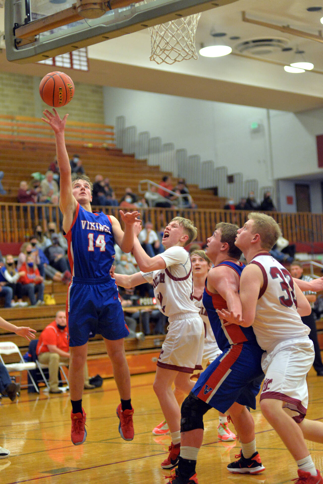 RYAN SPARKS | THE DAILY WORLD Willapa Valley forward Derek Fluke (14) is defended by Hoquiam guard Michael Lorton-Watkins during the Vikings 66-38 season-opening win on Tuesday at Hoquiam Square Garden.