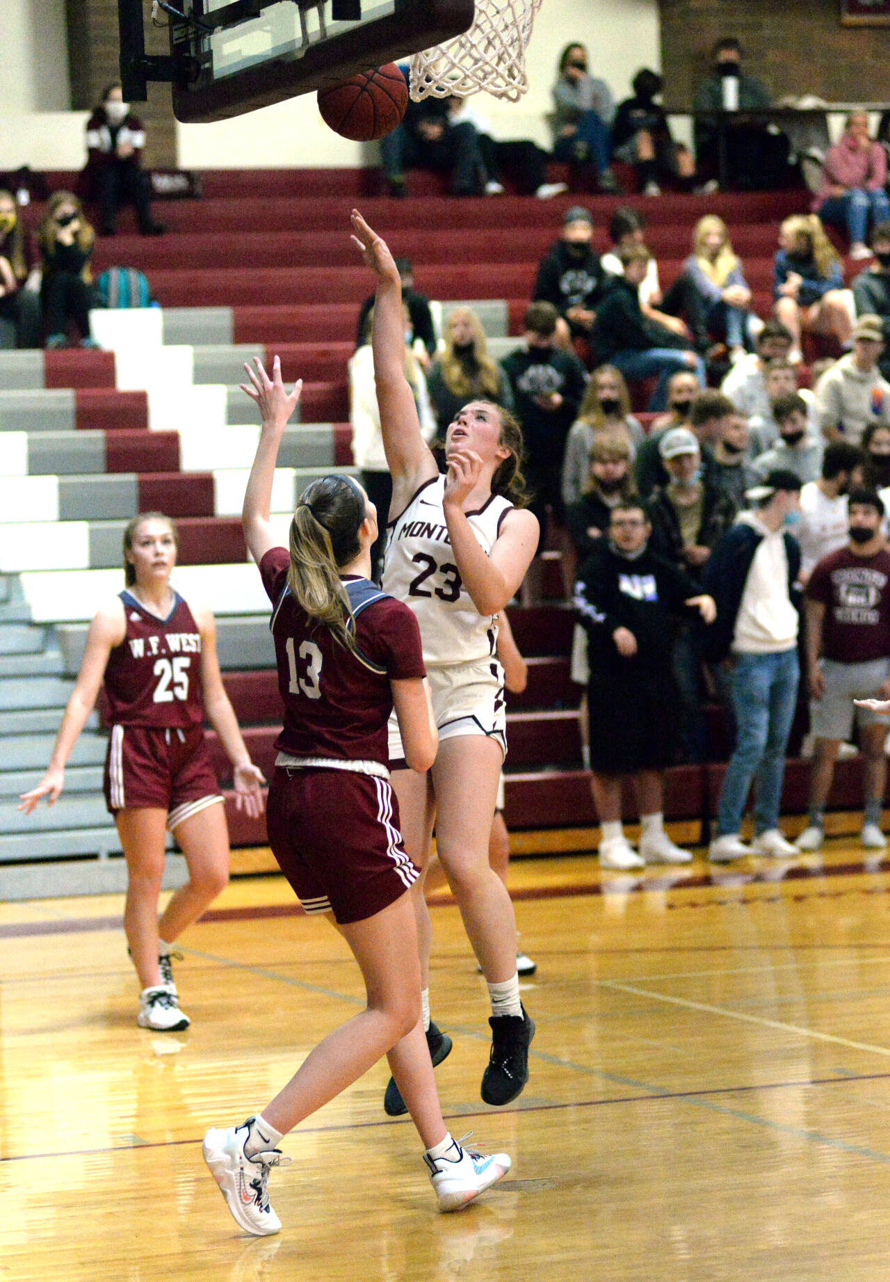 RYAN SPARKS | THE DAILY WORLD Montesano senior Paige Lisherness (23) scores from the post against WF West’s Drew Brumfield during Monte’s 48-29 loss on Tuesday at Montesano High School.
