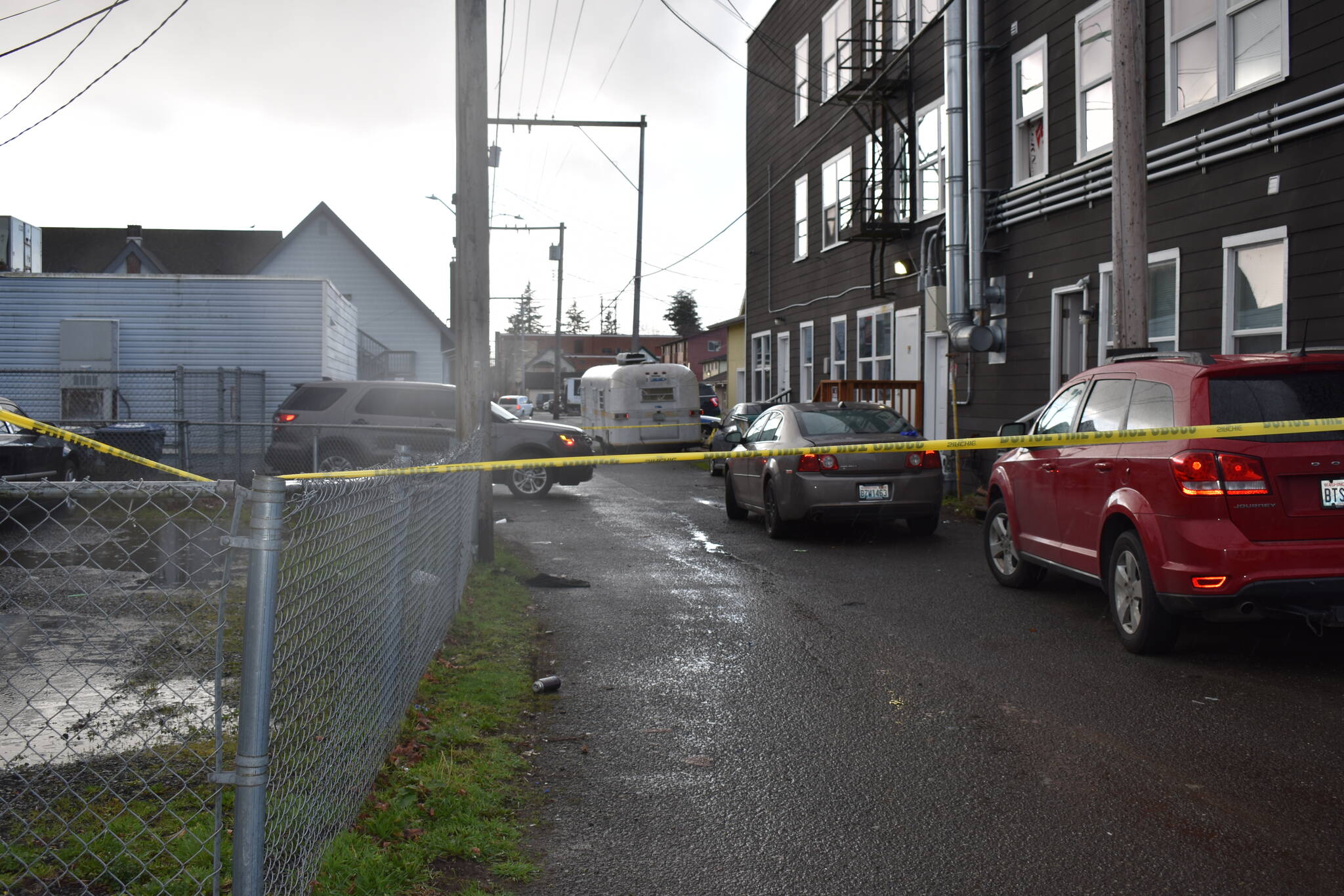 Aberdeen Police tape was affixed to street poles on Wednesday outside of the alleyway behind the apartment building at 213 N. F St., in Aberdeen, which was the scene of a shooting. Aberdeen Police Detective Sgt. Dave Cox said the Aberdeen High School, which was on a modified lockdown, was because because of protocol, given where the shooting occurred. (Matthew N. Wells | The Daily World)