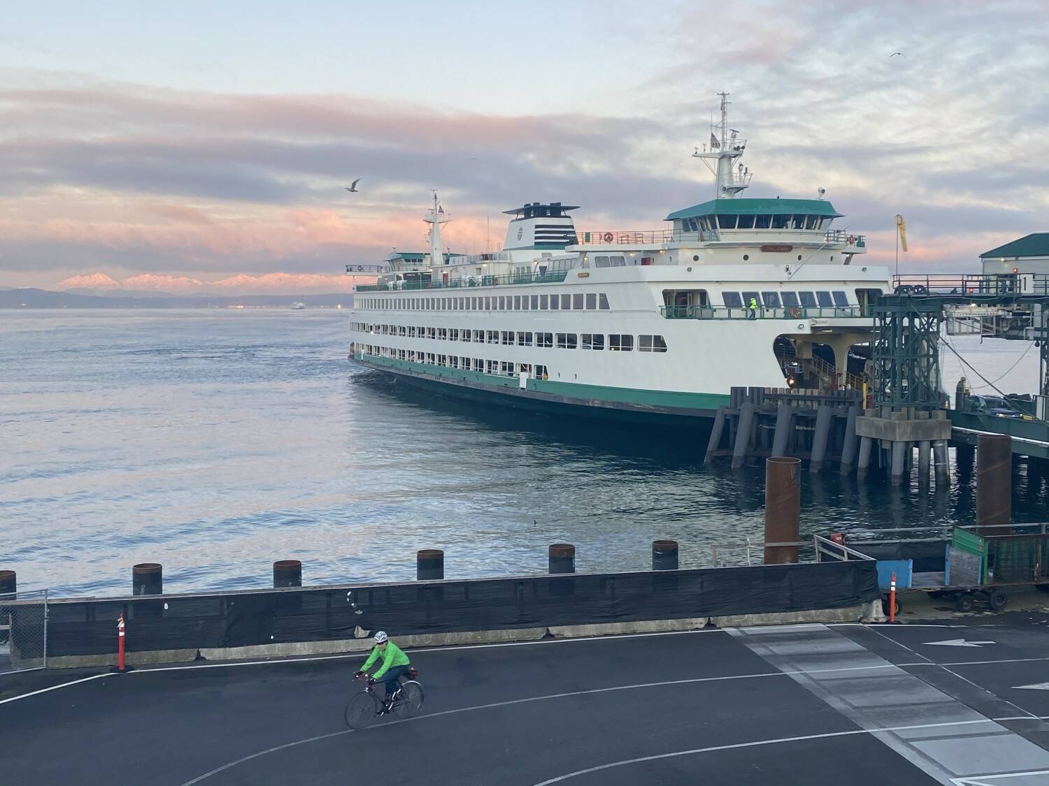 A cyclist rides from a ferry into downtown Seattle during a lonely commute March 9, as more people were working from home due to the coronavirus. Tribune News Service